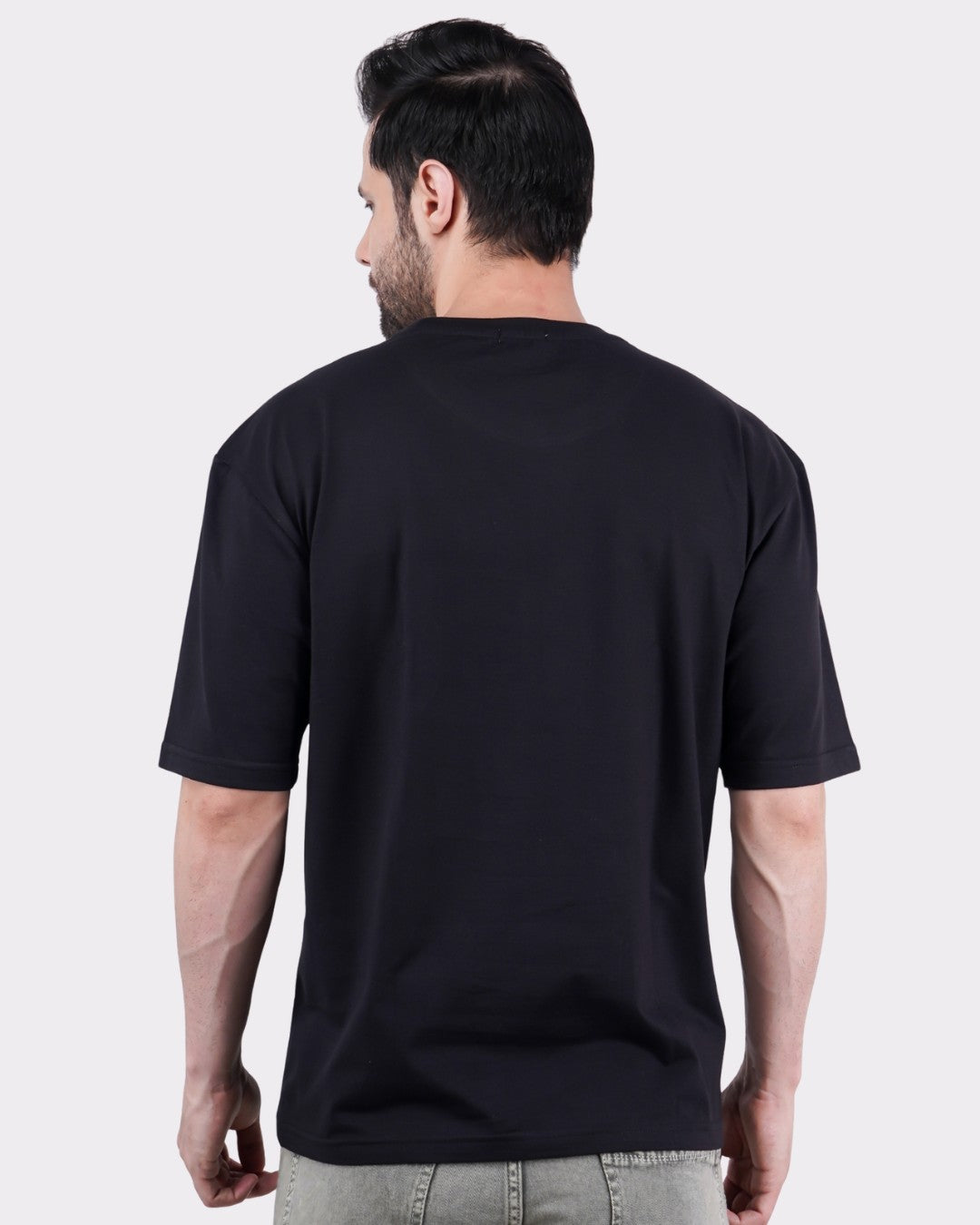 Back view of a man wearing black Animal Archetype Oversized T-Shirt For Men by Bandar Baant Collections