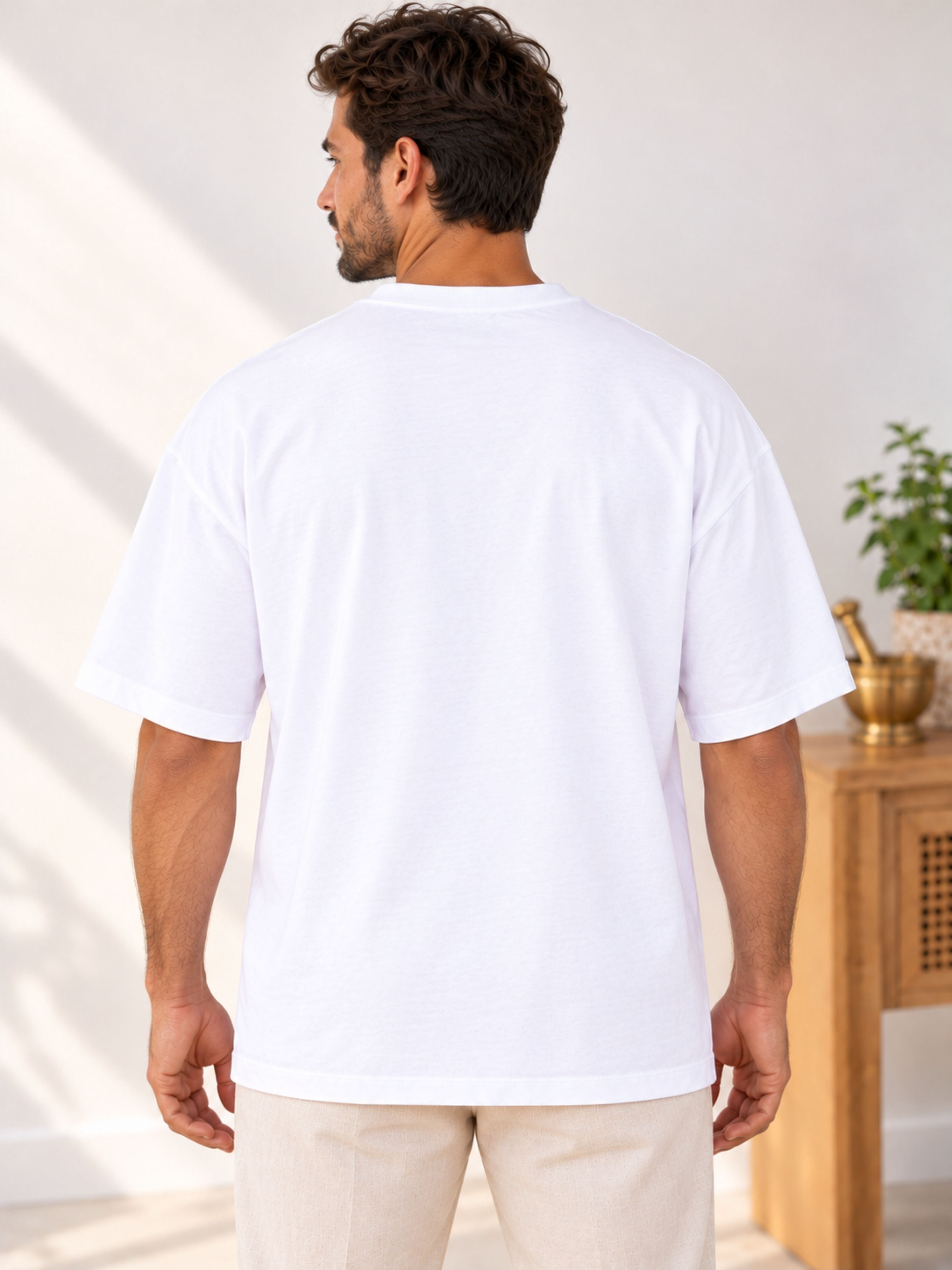 Back view of man wearing oversized fit Ayurvedic Doctor Statement Tshirt For Men in white by Bandar Baant Collections