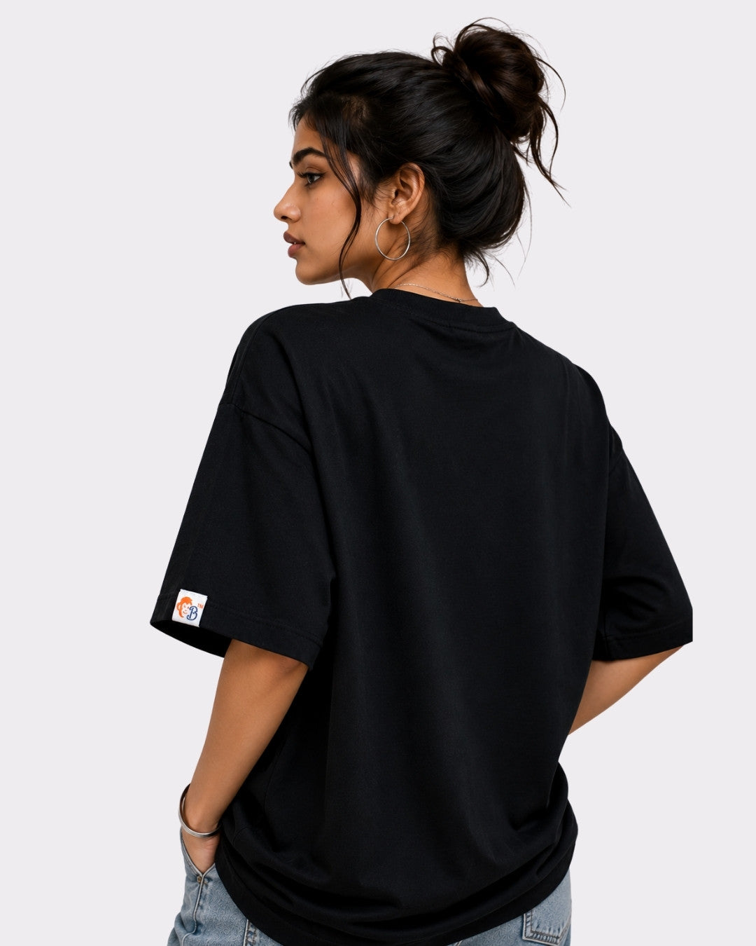 Back view of woman wearing black Dancer Oversized T-shirt For Women from Bandar Baant Collections