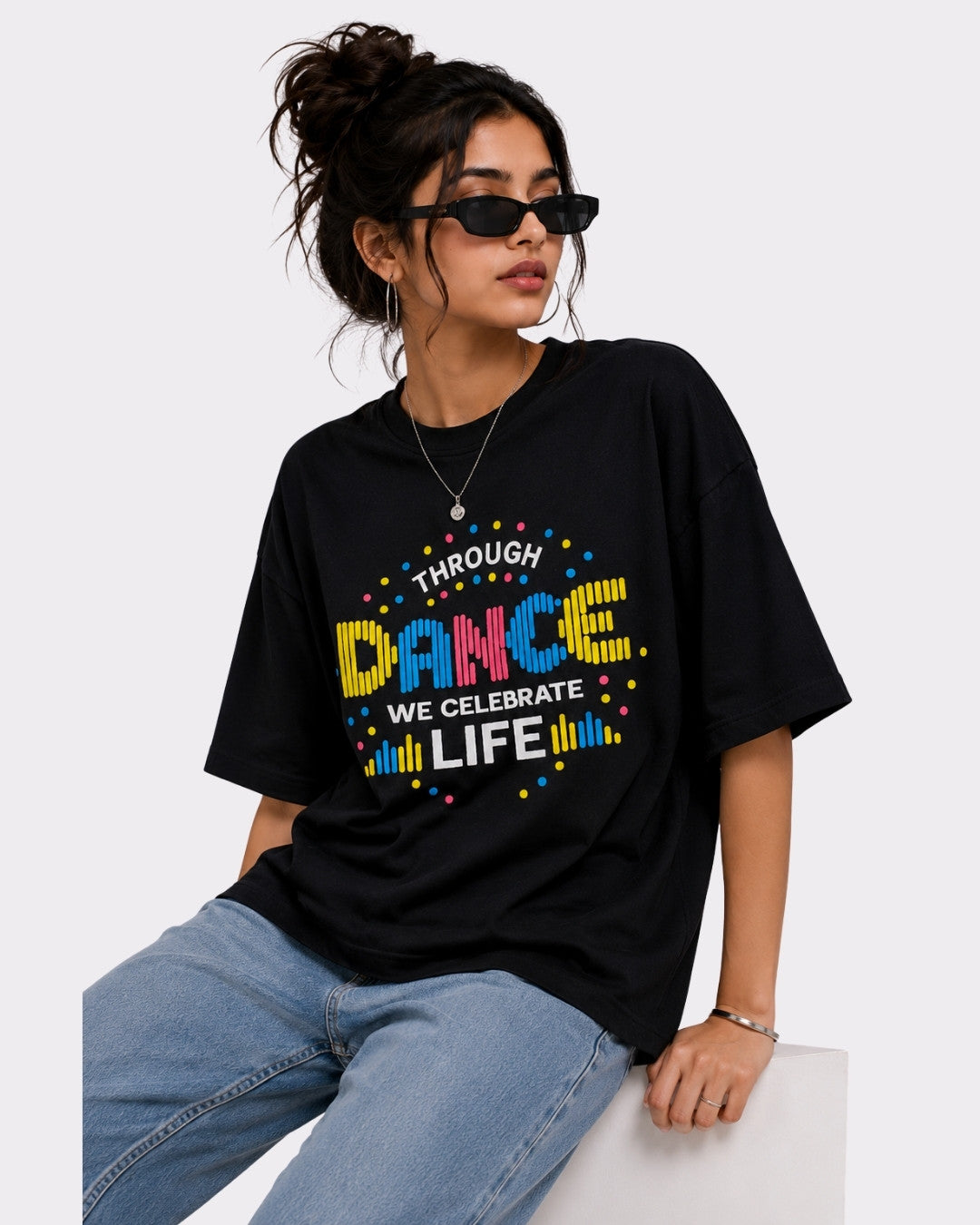 Black Dancer Oversized T-shirt For Women with colorful dance print worn with jeans by model