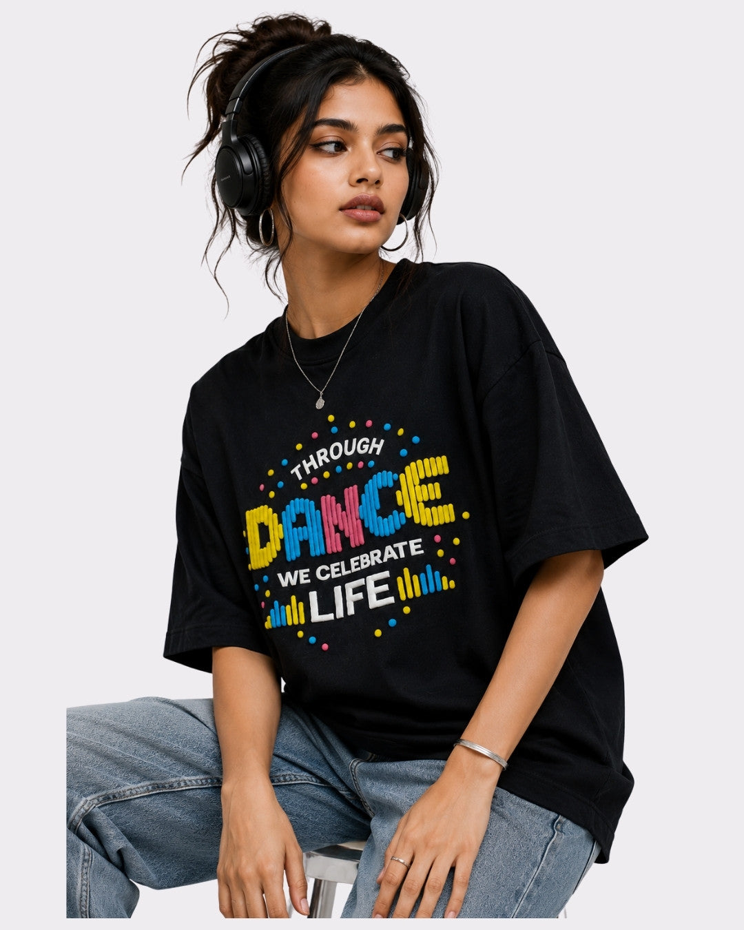 Black Dancer Oversized T-shirt For Women with colorful text graphic worn by woman with headphones