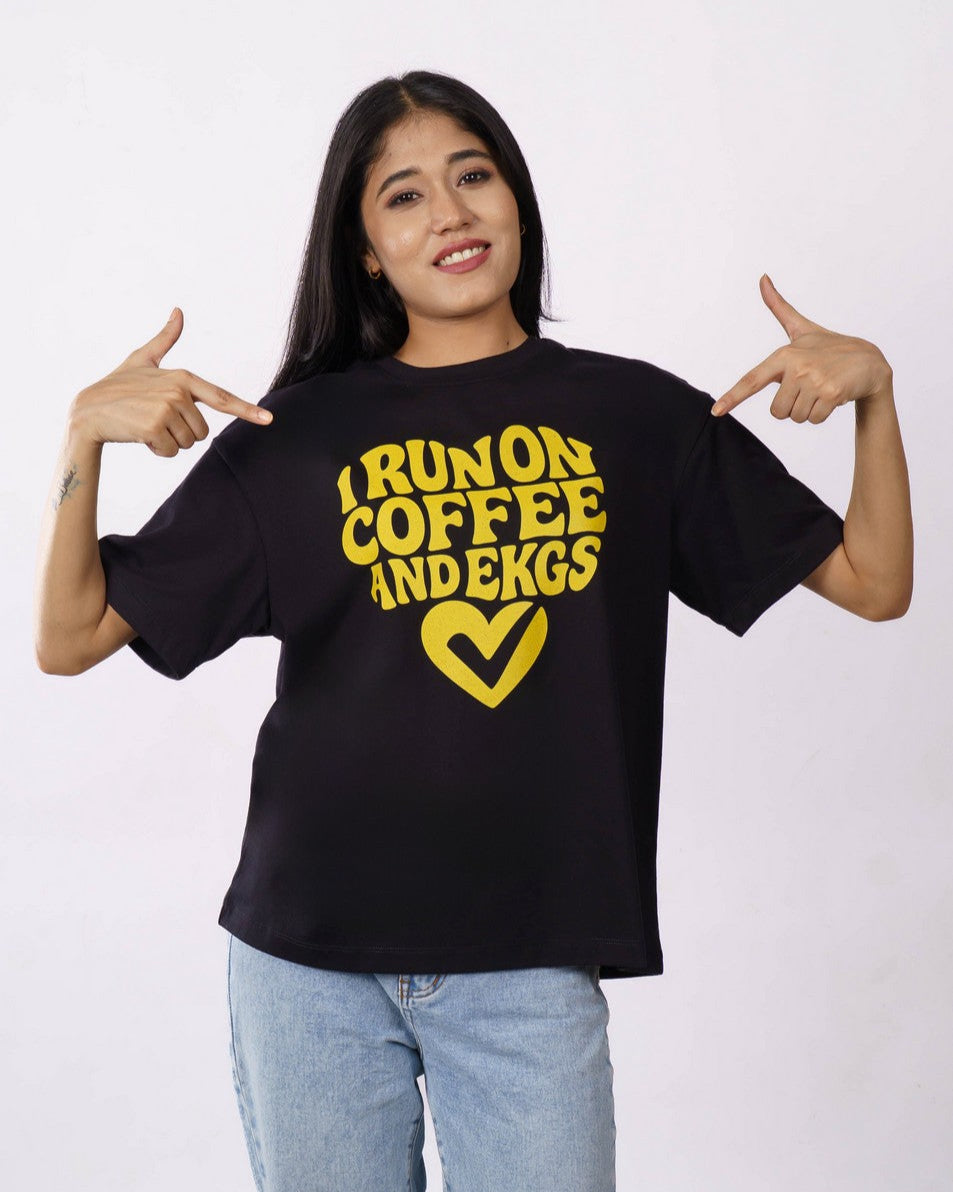 Woman wearing oversized fit Cardiologist Trendy Tshirt For Women black with yellow text design