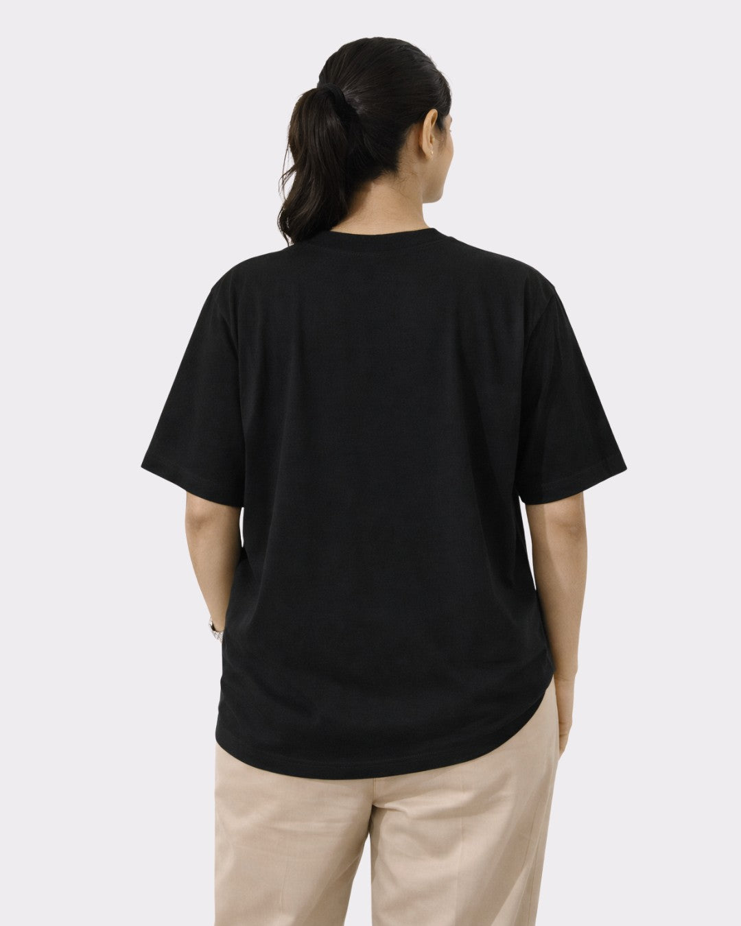 Back view of woman wearing oversized fit black Chartered Accountant Quote T-shirt For Women from Bandar Baant Collections
