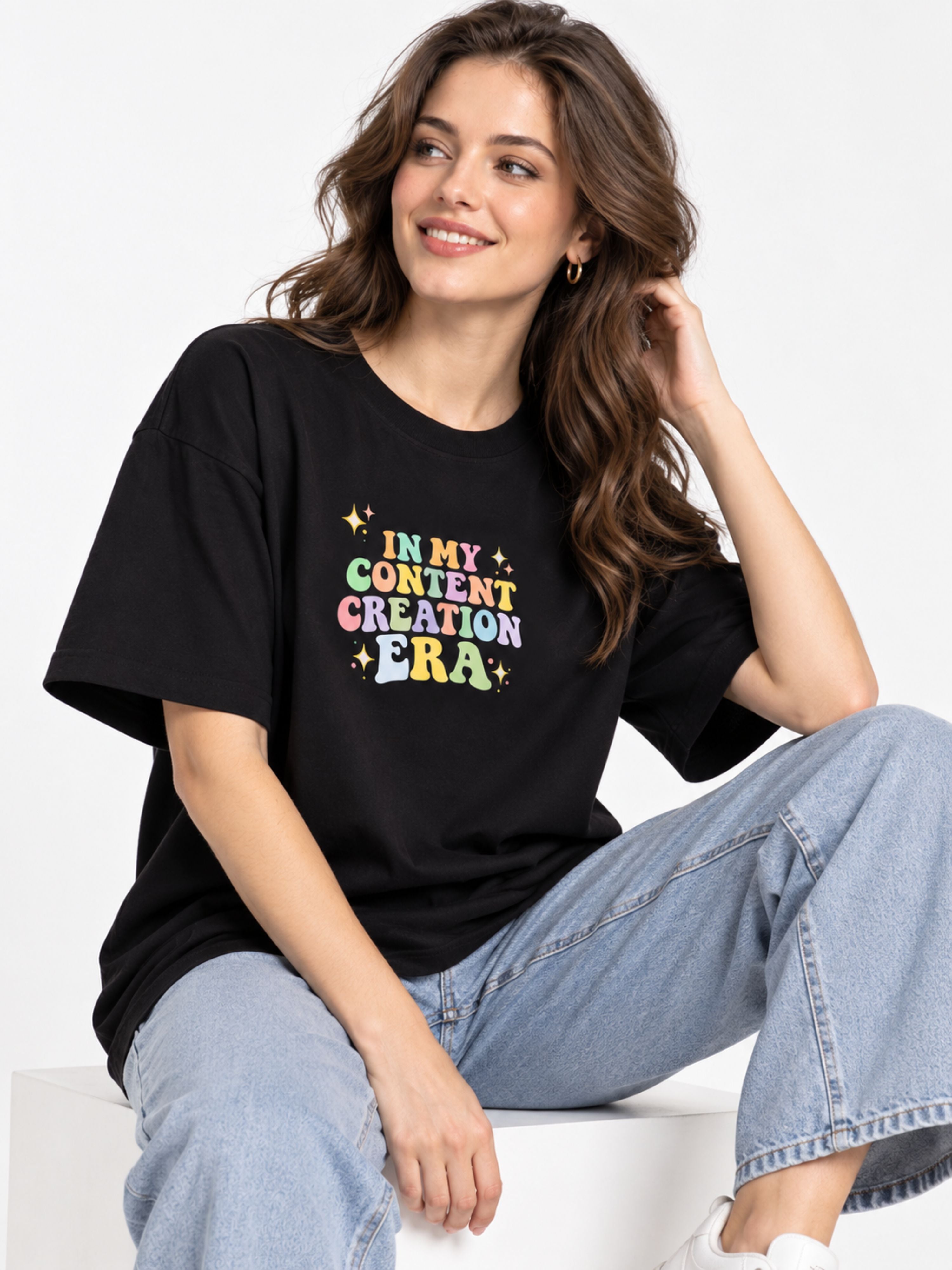 Content Creator T-Shirt For Women oversized fit black tee with colorful print worn by smiling woman