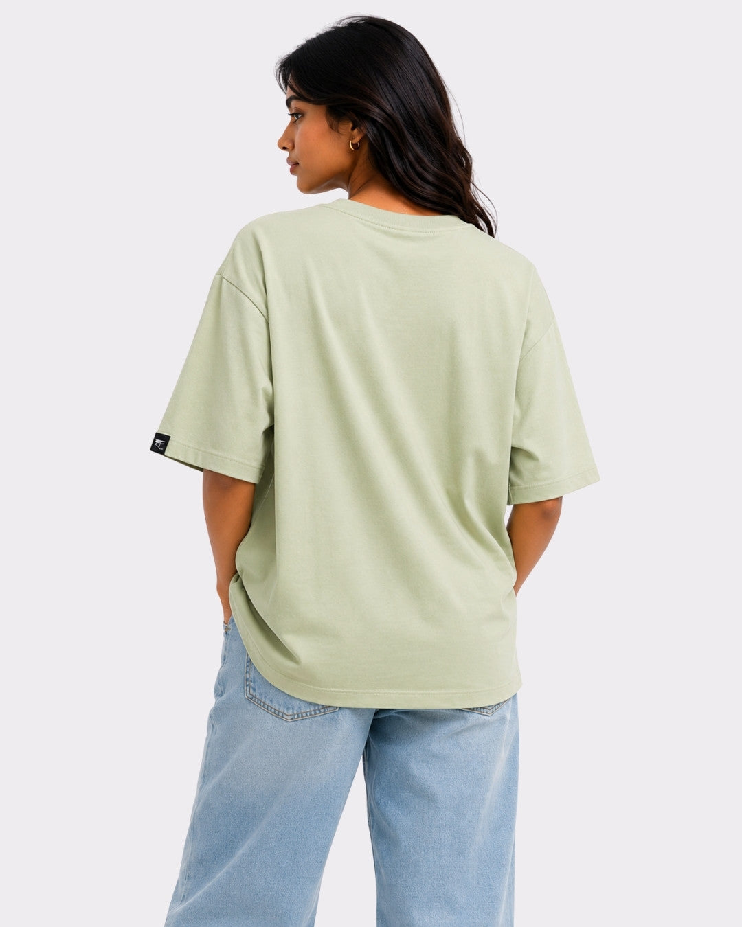 Back view of woman wearing Dance to Your Own Rhythm Oversized T-shirt For Women in light green with loose fit
