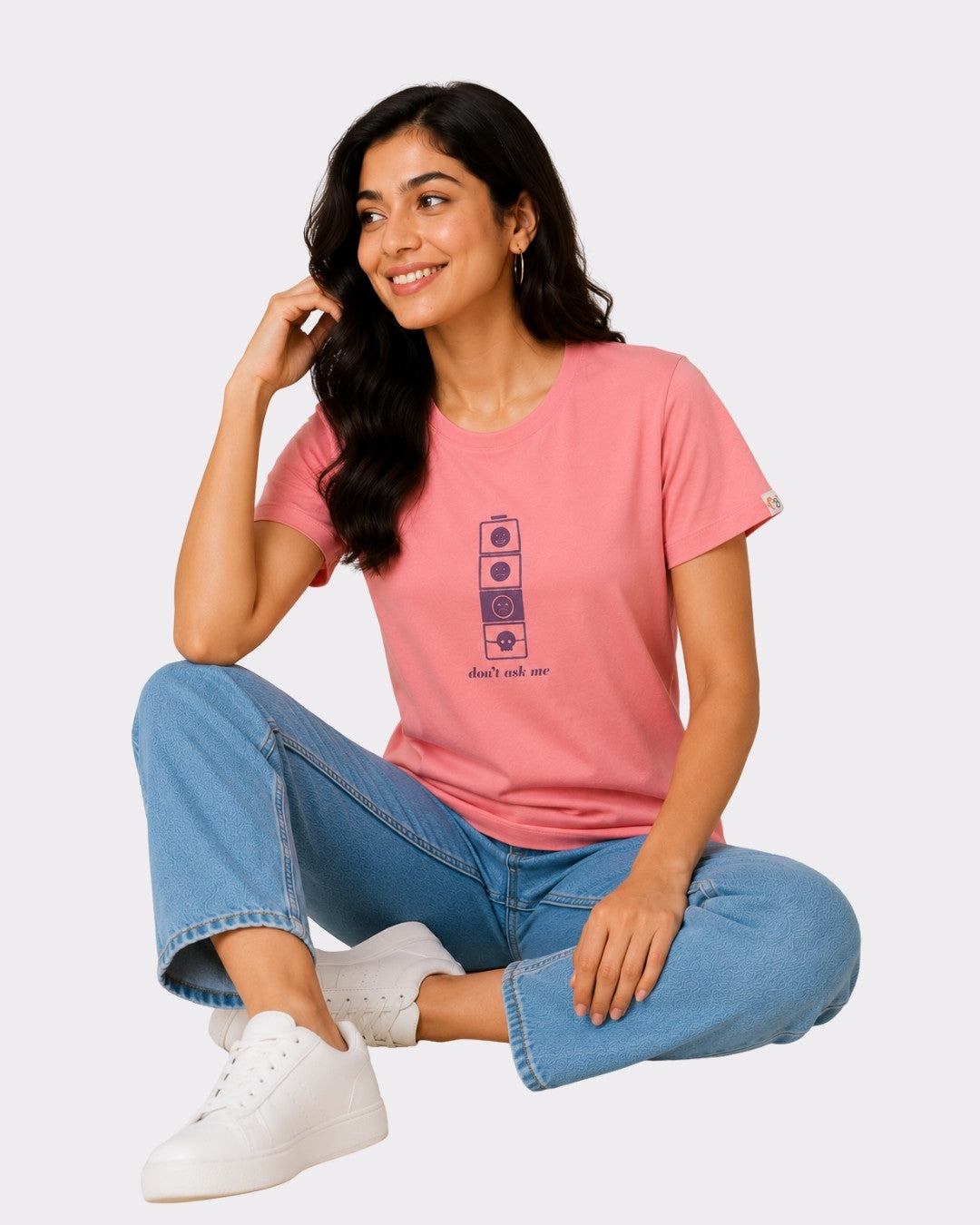Regular Fit T-shirt For Women Pink Color worn by a woman sitting cross-legged in blue jeans and white sneakers