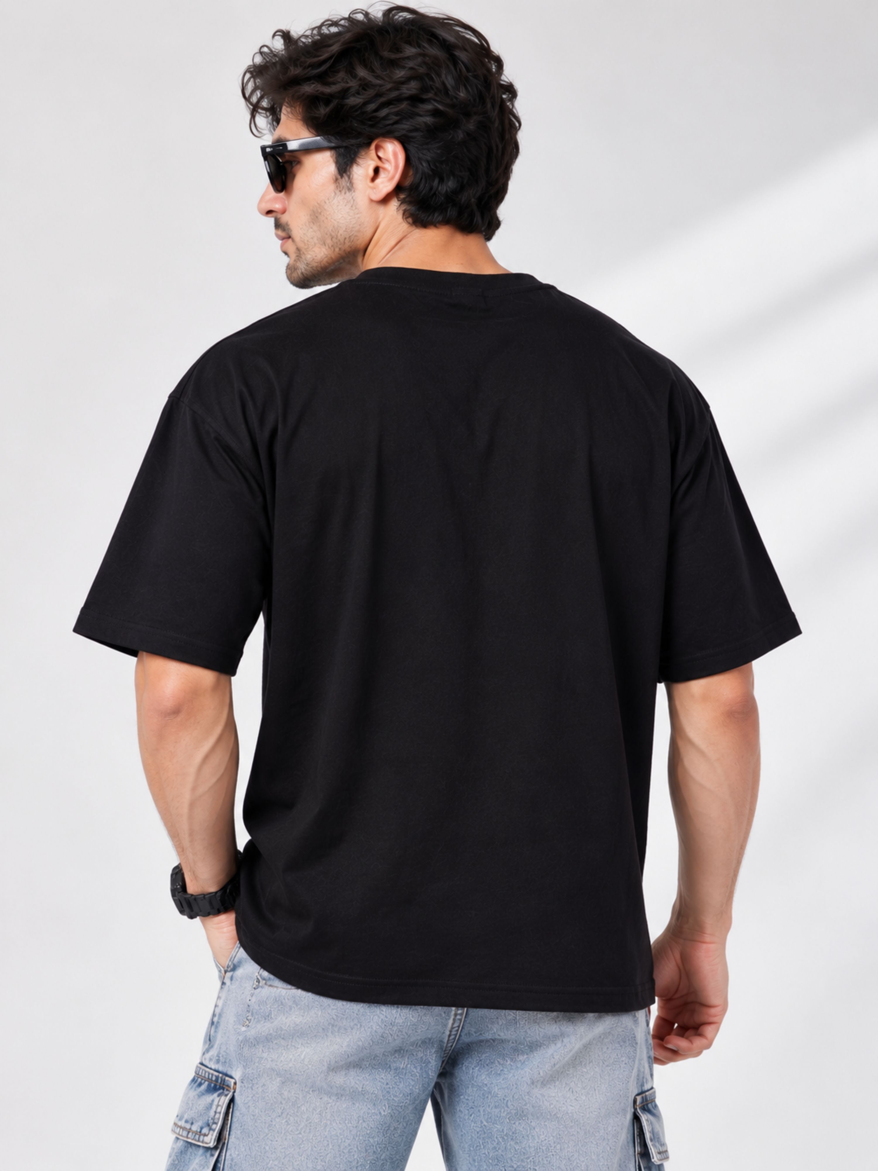 Back view of man wearing oversized fit black Gym Enthusiast Graphic T-shirt For Men by Bandar Baant Collections