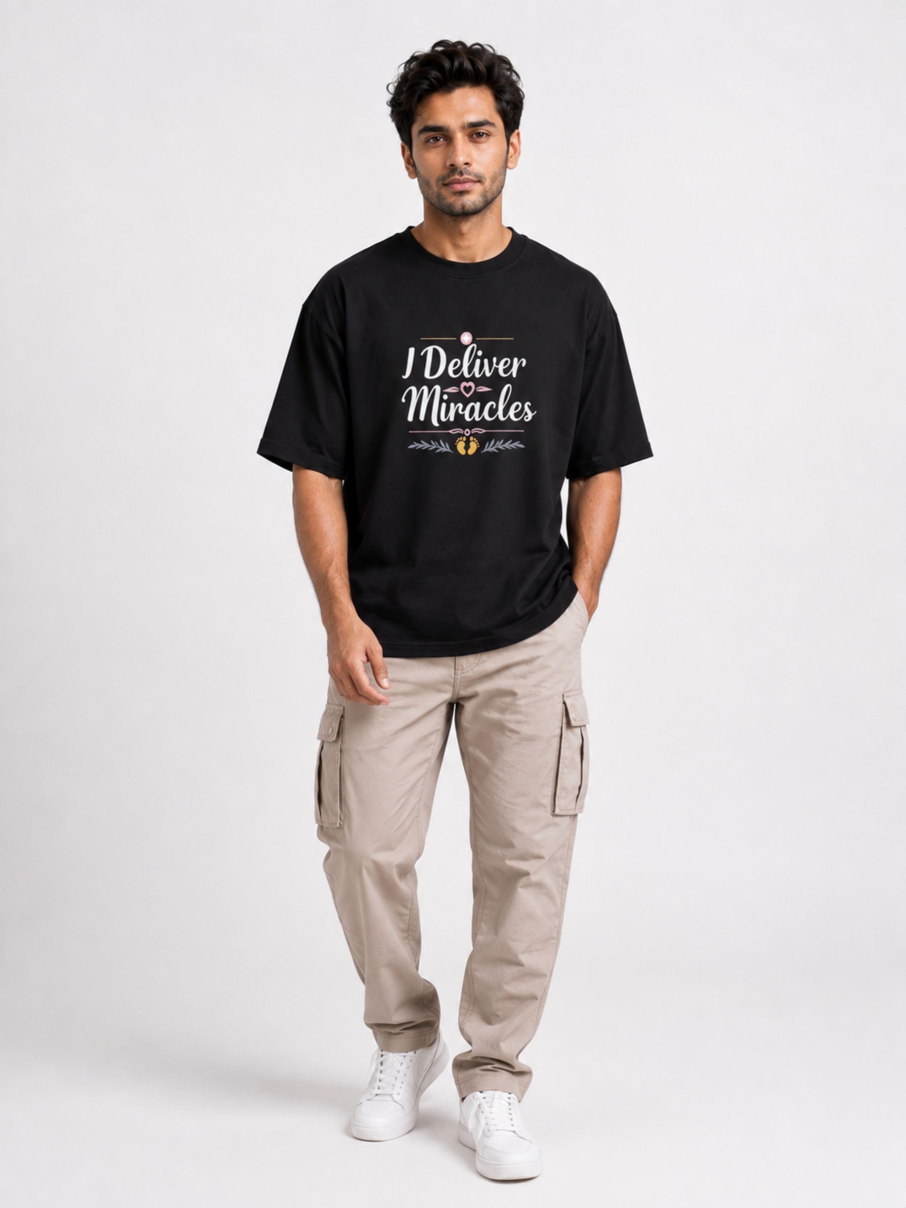 Gynaecologist Quote Tshirt For Men oversized fit black tee with I Deliver Miracles text worn by male model