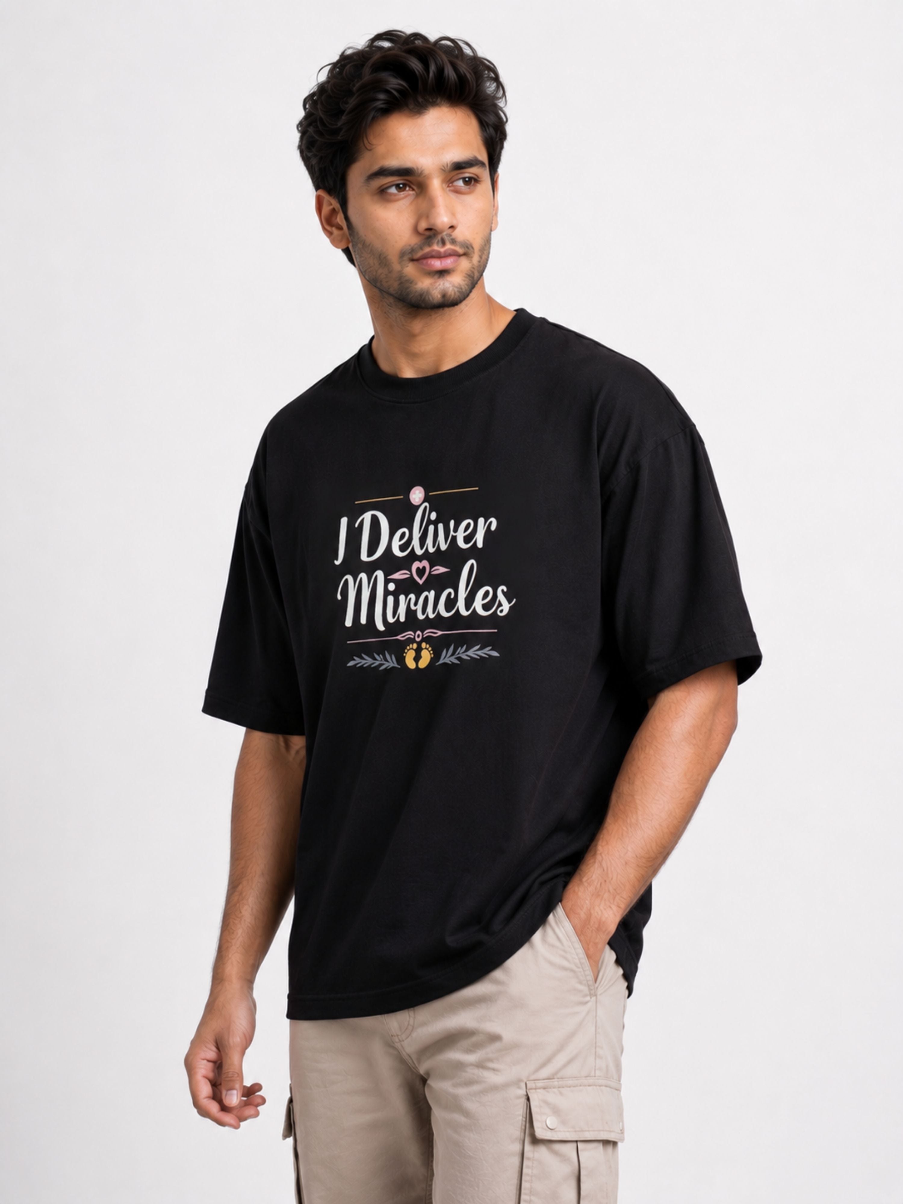 Black oversized fit Gynaecologist Quote Tshirt For Men with I Deliver Miracles text worn by male model
