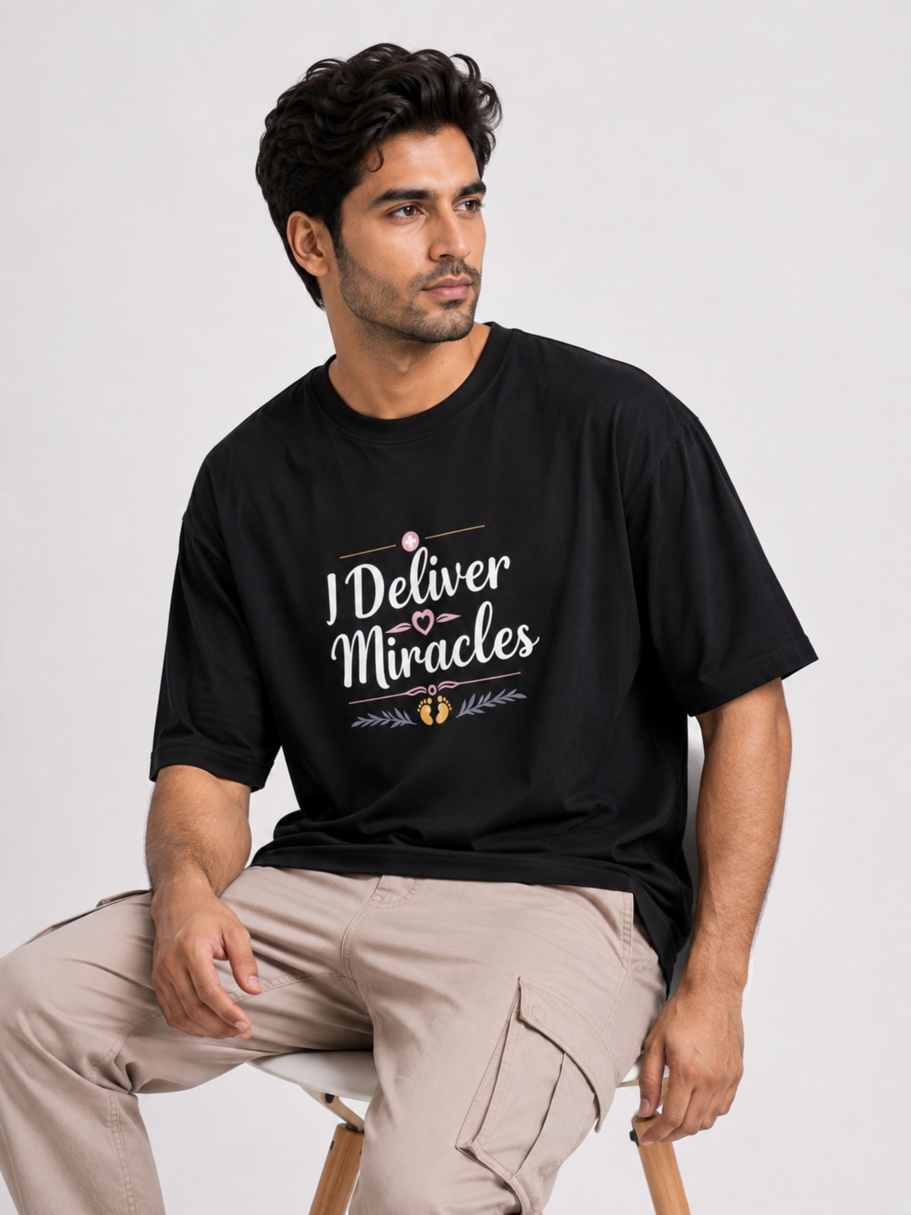 Black oversized fit Tshirt from Bandar Baant Collections with I Deliver Miracles design Gynaecologist Quote Tshirt For Men