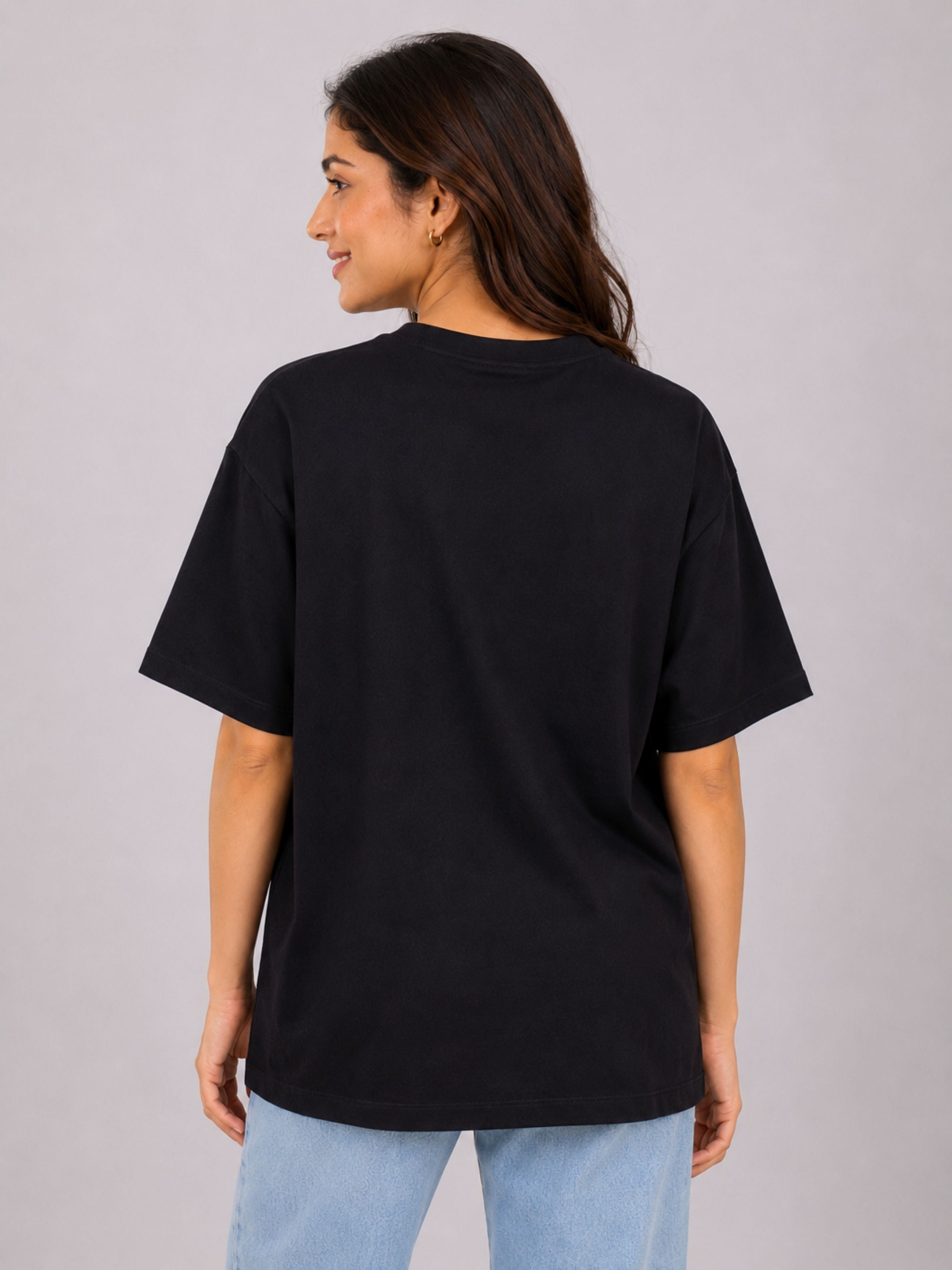 Back view of a woman wearing a black oversized fit Gynaecologist T-Shirt For Women from Bandar Baant Collections