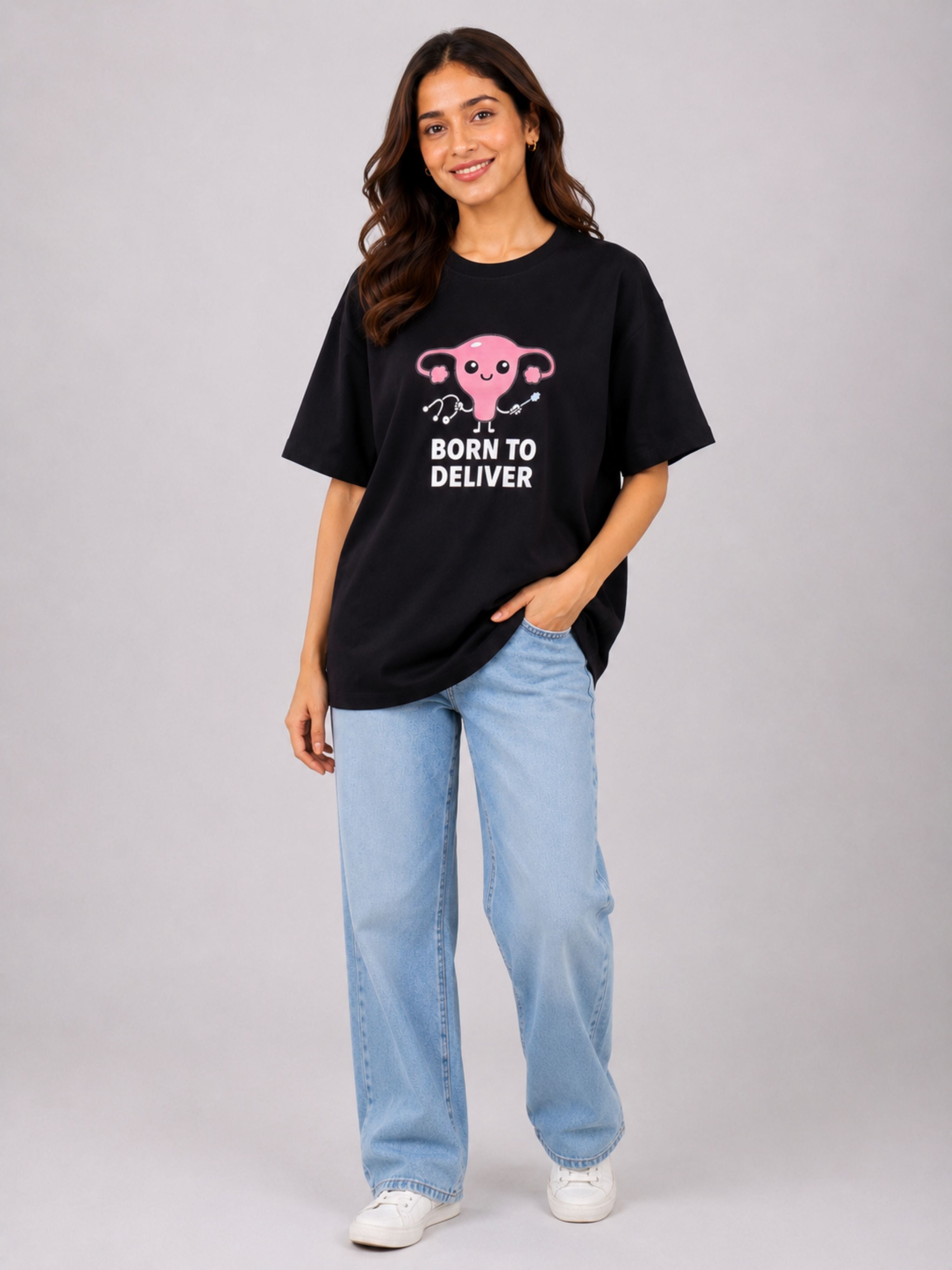 Oversized fit Gynaecologist T-Shirt For Women in black with Born to Deliver graphic worn with light blue jeans