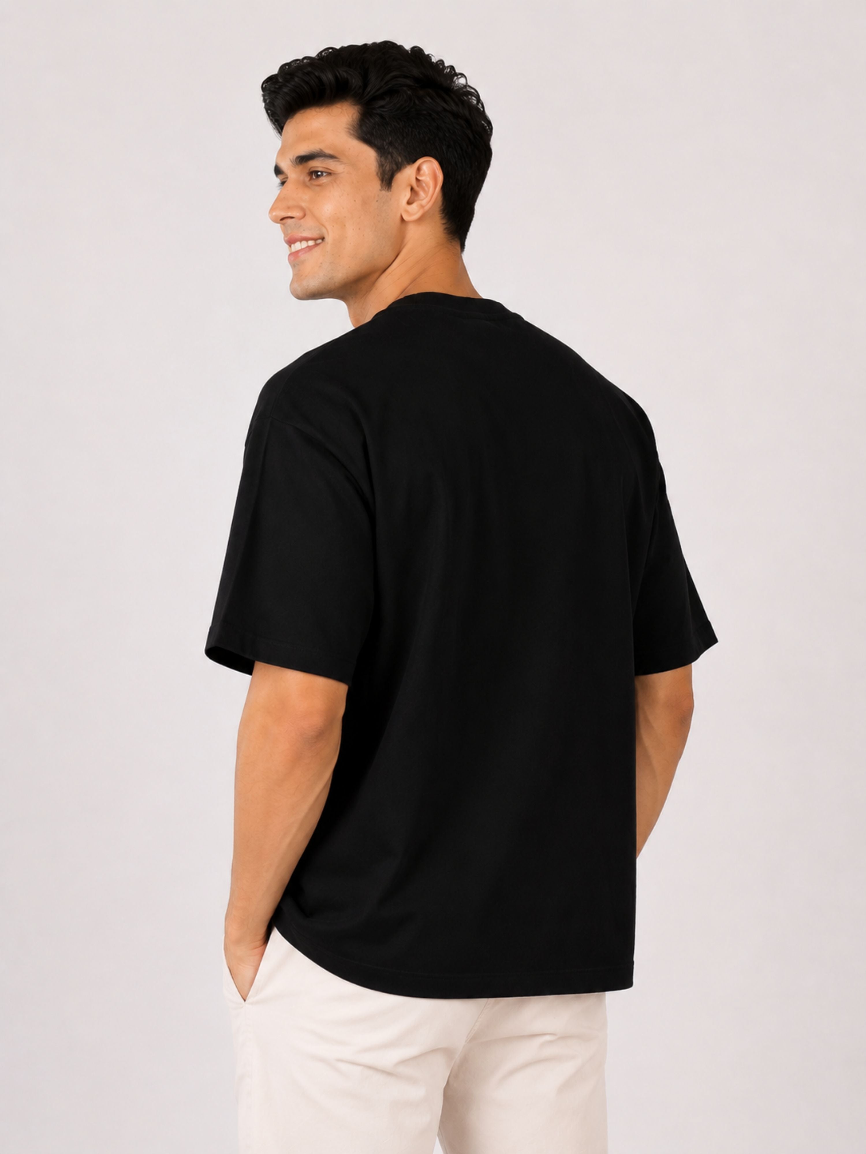 Back view of a man wearing a black oversized fit Gynaecologist Trendy Graphic Tshirt For Men