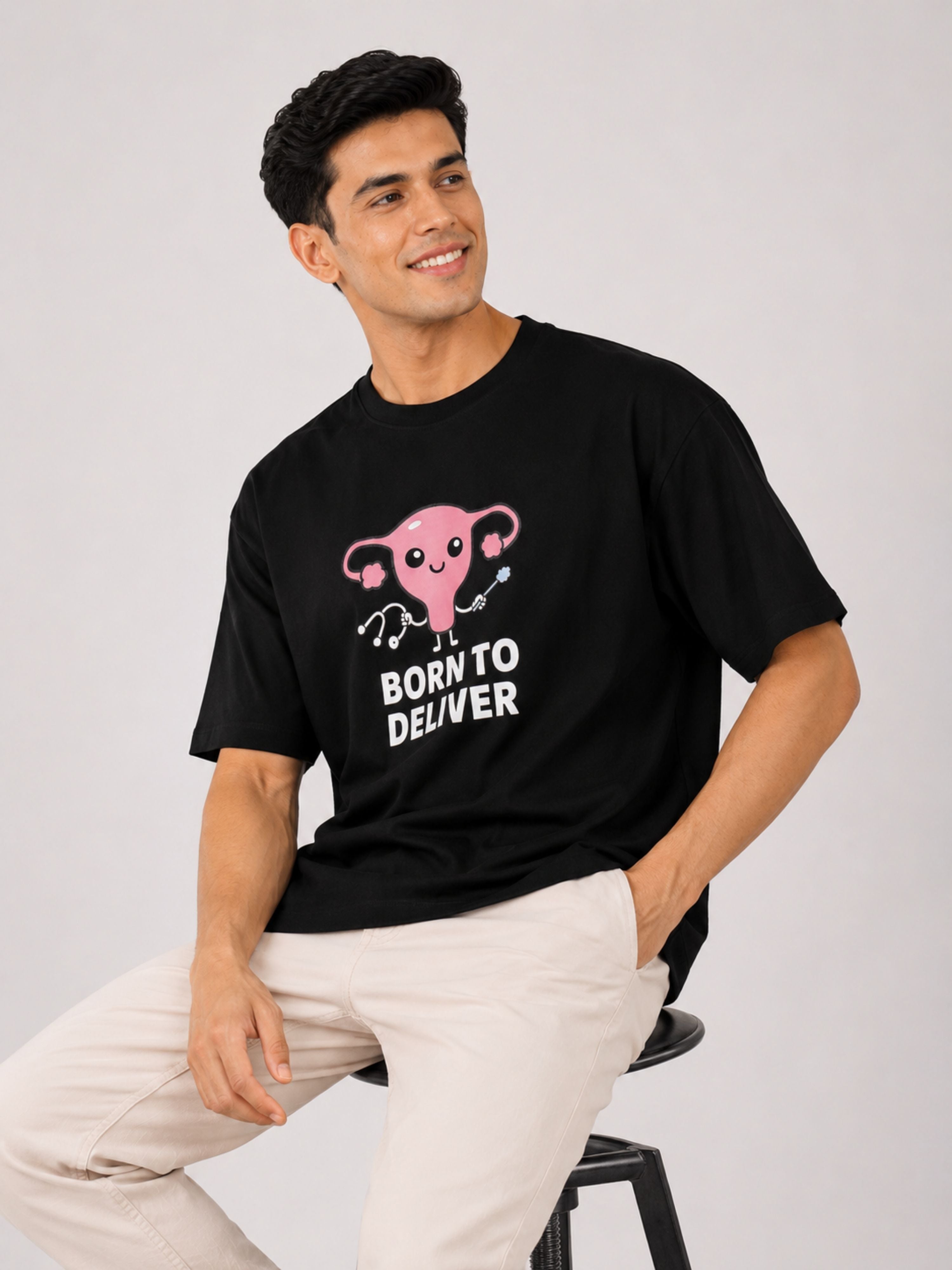 Black oversized fit Gynaecologist Trendy Graphic Tshirt For Men with pink uterus design and Born to Deliver text