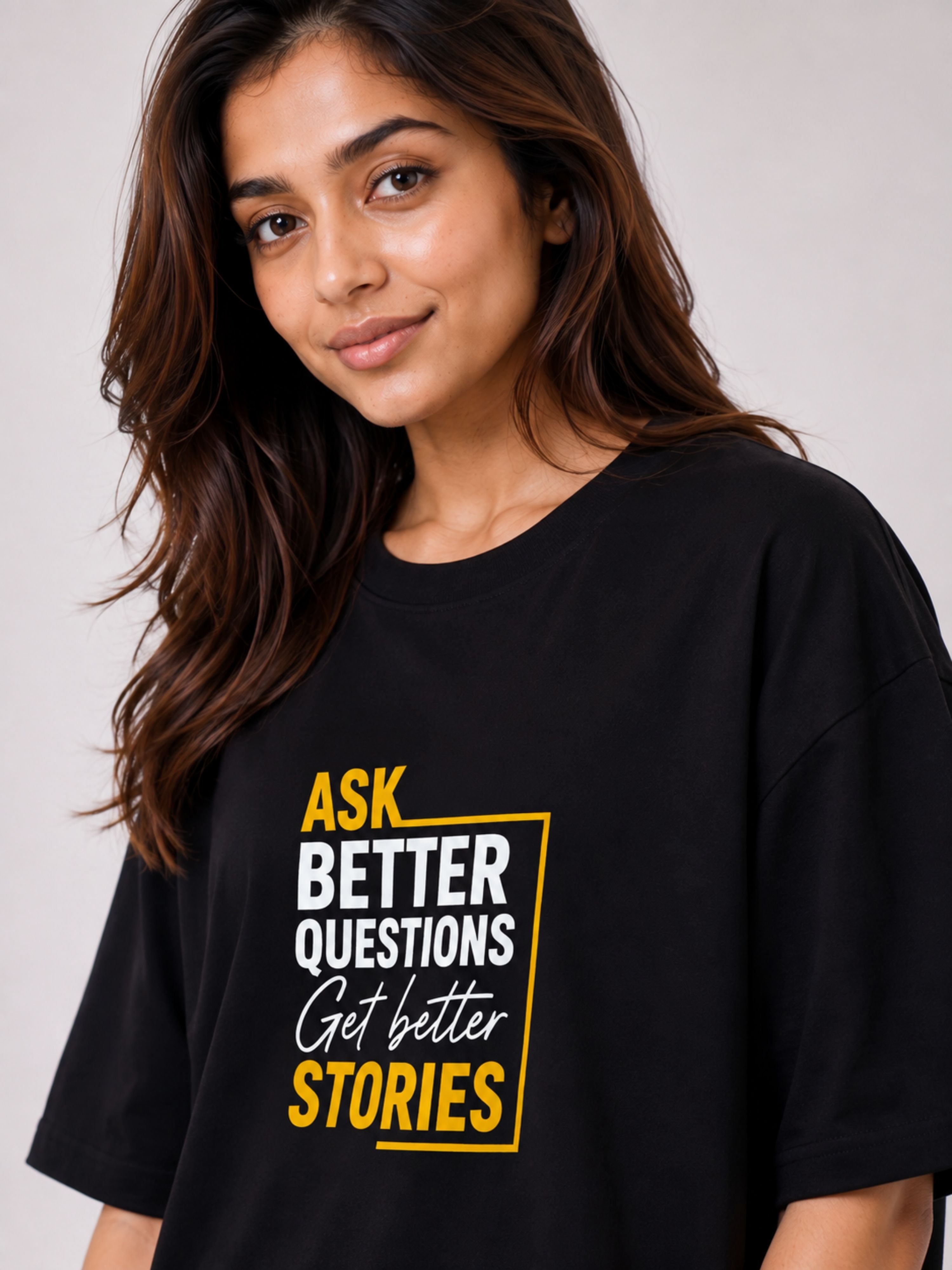 Black oversized fit Journalists Quote T-shirt For Women with yellow and white text saying Ask Better Questions Get Better Stories