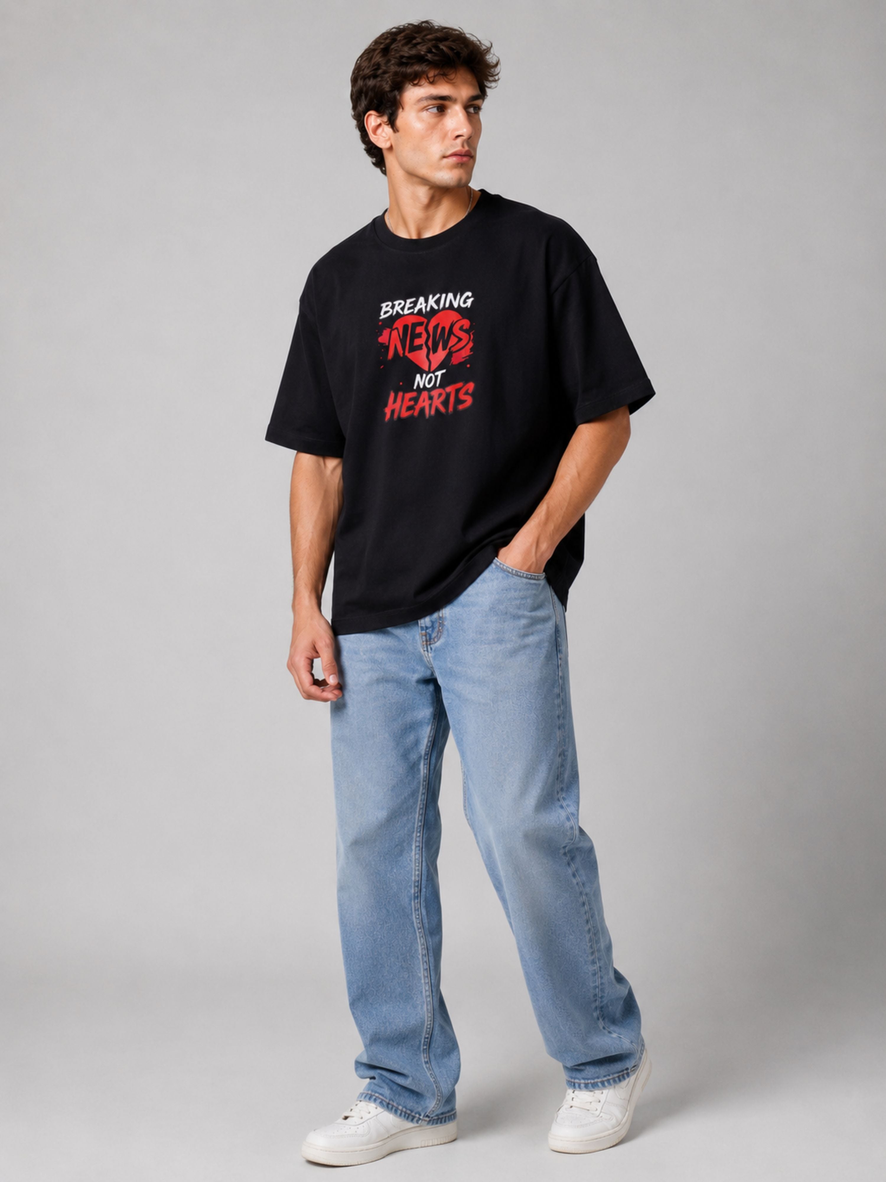 Oversized fit black Journalists T-shirt For Men with breaking news print worn with light blue jeans