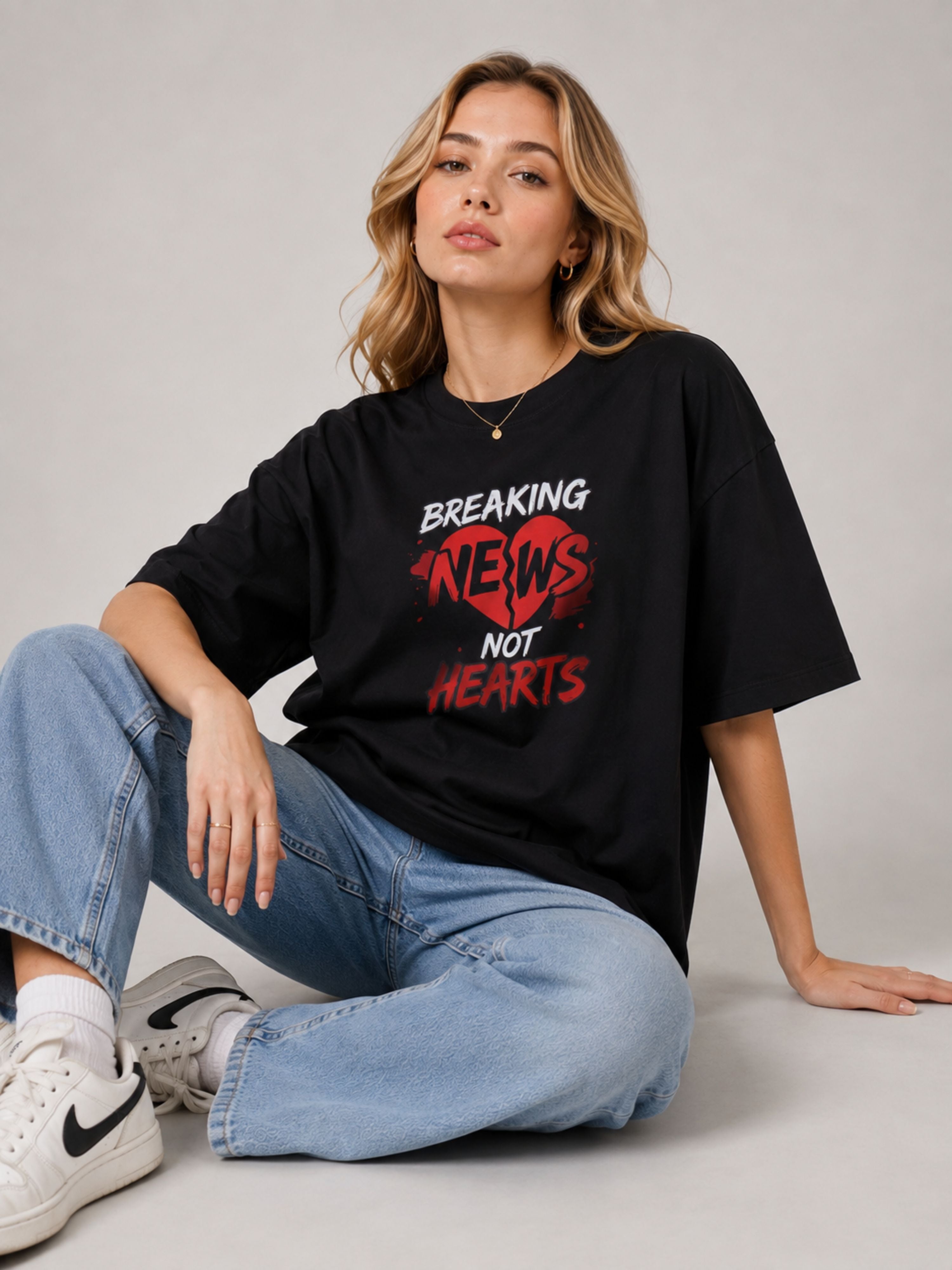 Oversized fit Journalists T-Shirt For Women in black with Breaking News graphic worn with jeans and sneakers