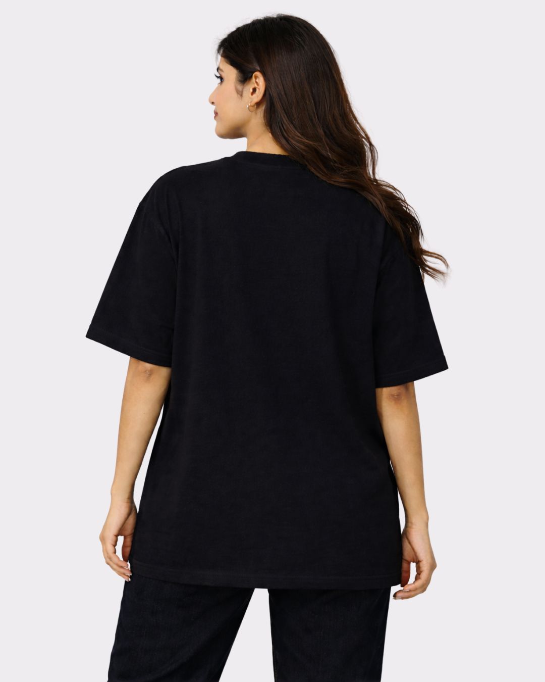 Back view of a woman wearing a black Lawyer Oversized Funky T-Shirt For Women by Bandar Baant Collections