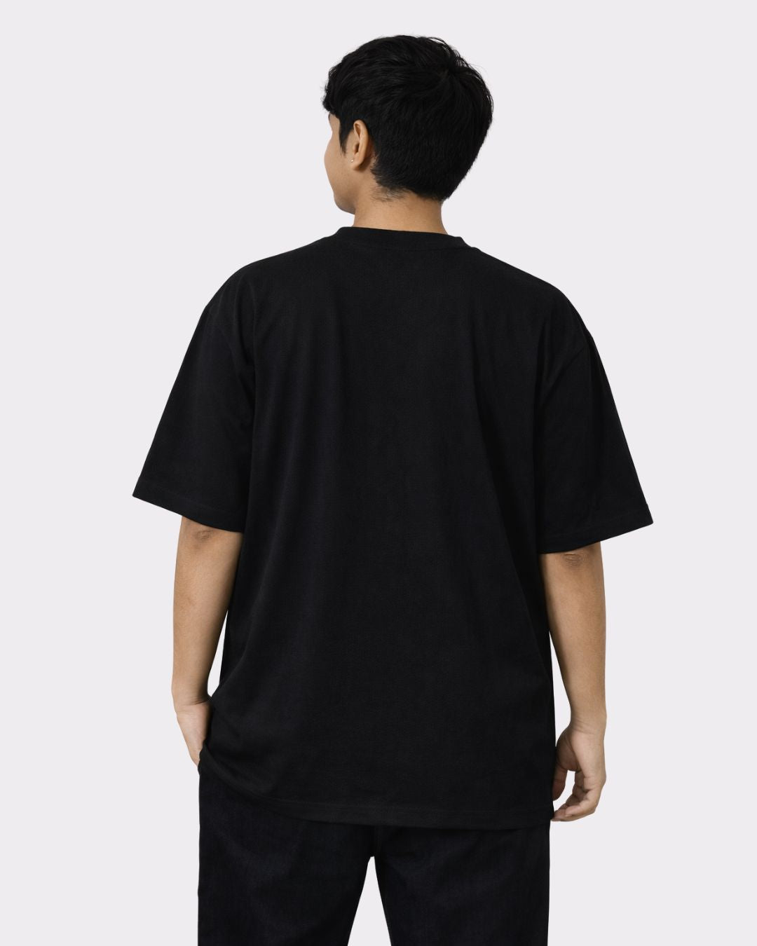 Back view of a man wearing black Lawyer Oversized Printed T-Shirt For Men from Bandar Baant Collections