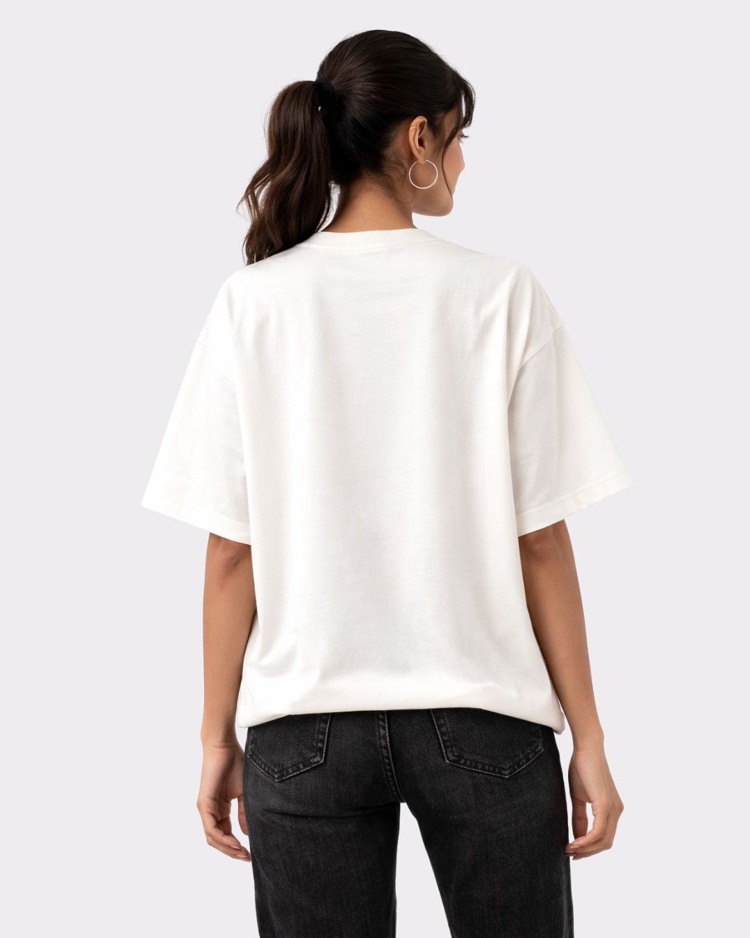Back view of a woman wearing a white Lawyer Oversized Printed T-Shirt For Women with short sleeves