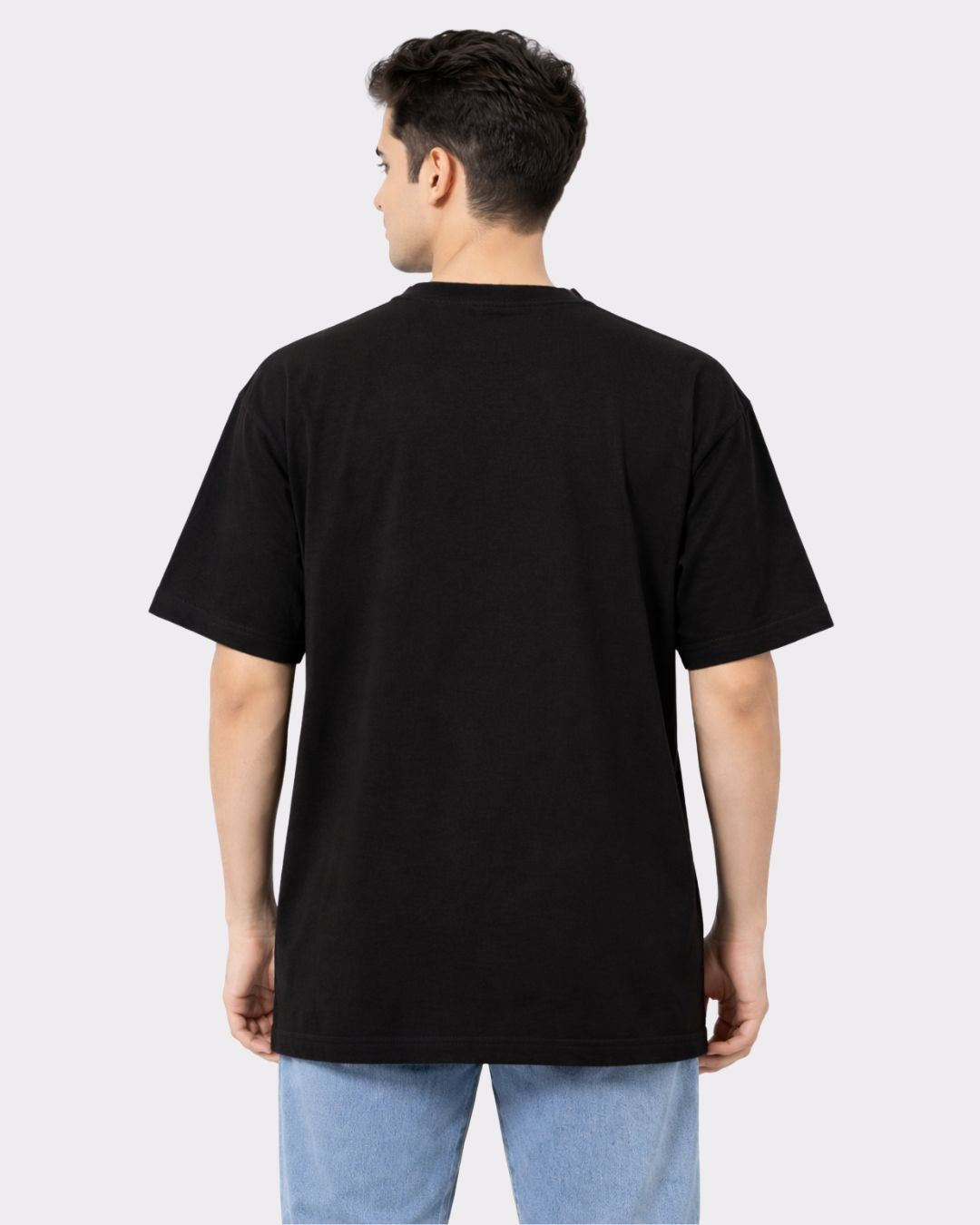 Back view of a man wearing a black Lawyer Oversized Quirky T-Shirt For Men by Bandar Baant Collections