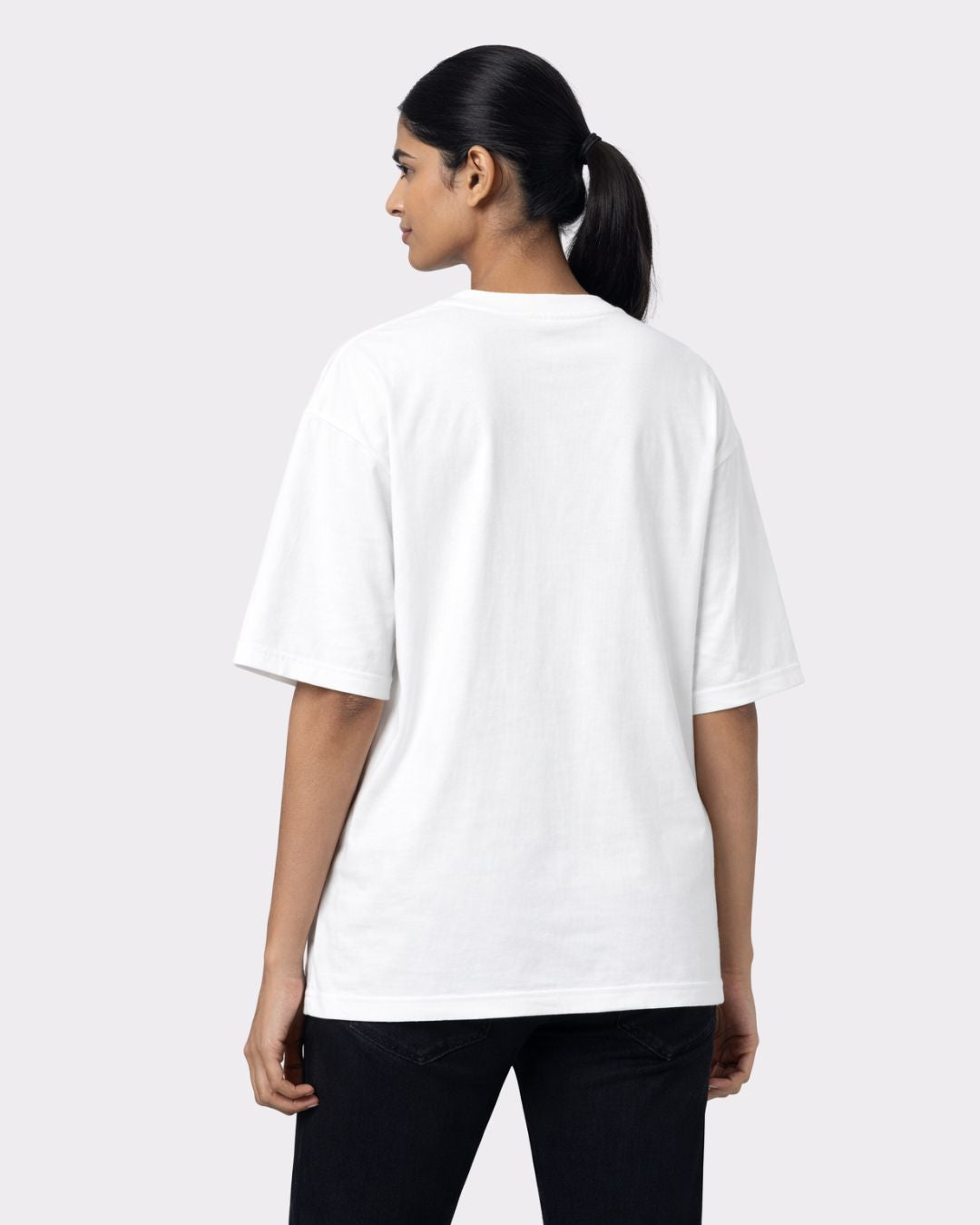 Back view of a woman wearing a white Lawyer Oversized Quote T-Shirt For Women from Bandar Baant Collections