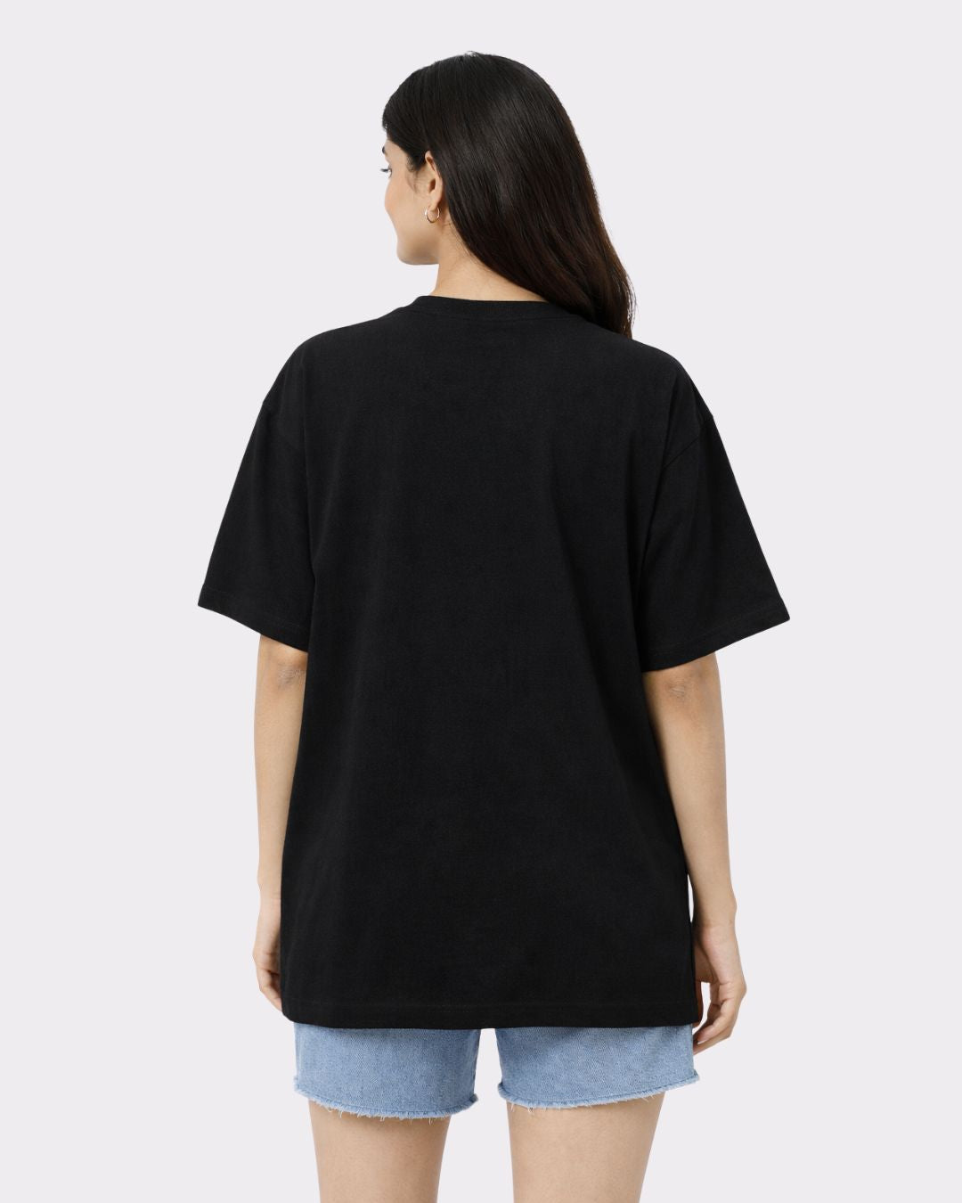 Back view of Lawyer Oversized T-Shirt For Women in black from Bandar Baant Collections worn with denim shorts