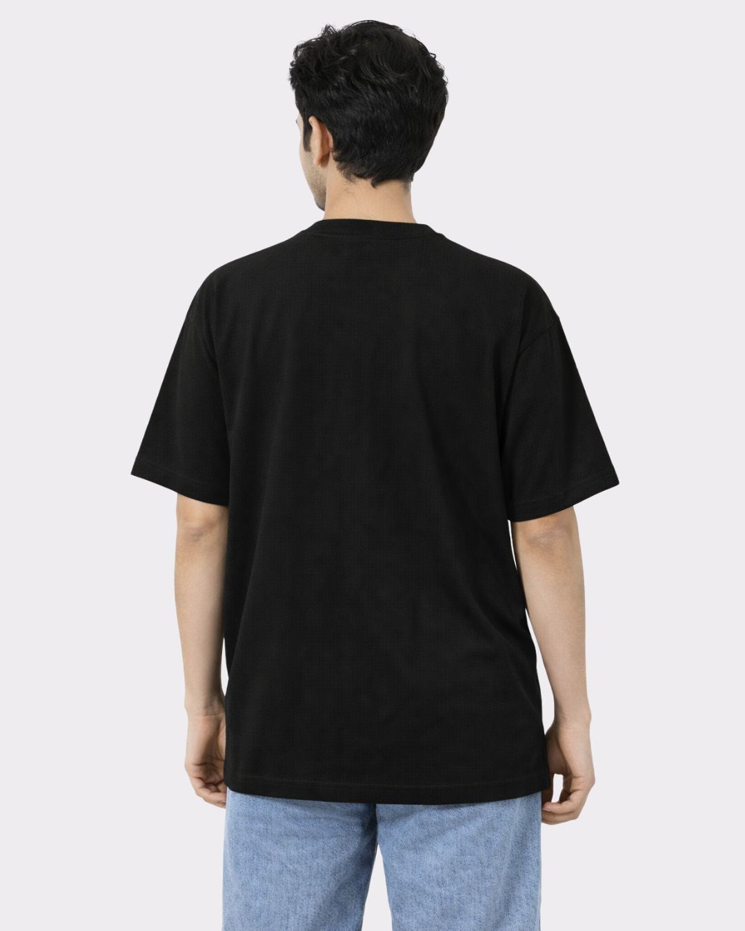 Back view of black Lawyer Oversized Trendy T-Shirt For Men by Bandar Baant Collections worn with blue jeans