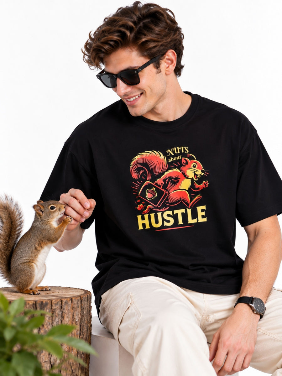 Man wearing oversized T-Shirt for Men with squirrel graphic and hustle text from Bandar Baant Collections