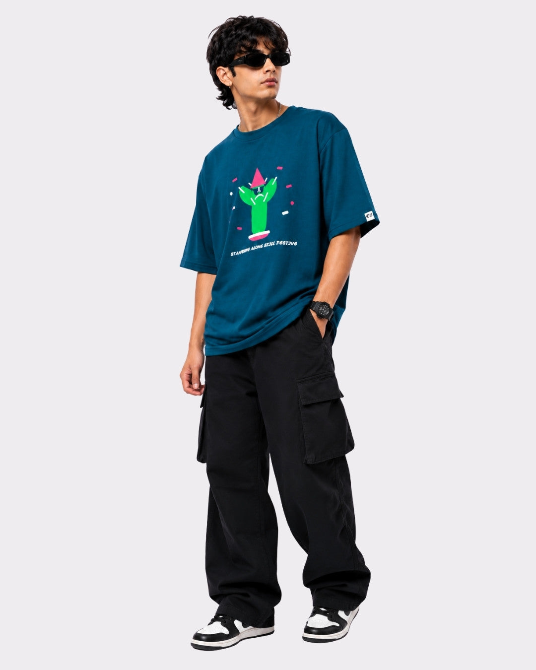 Oversized T-Shirt for Men Trendy Color Teal by Bandar Baant Collections worn with black cargo pants and sneakers