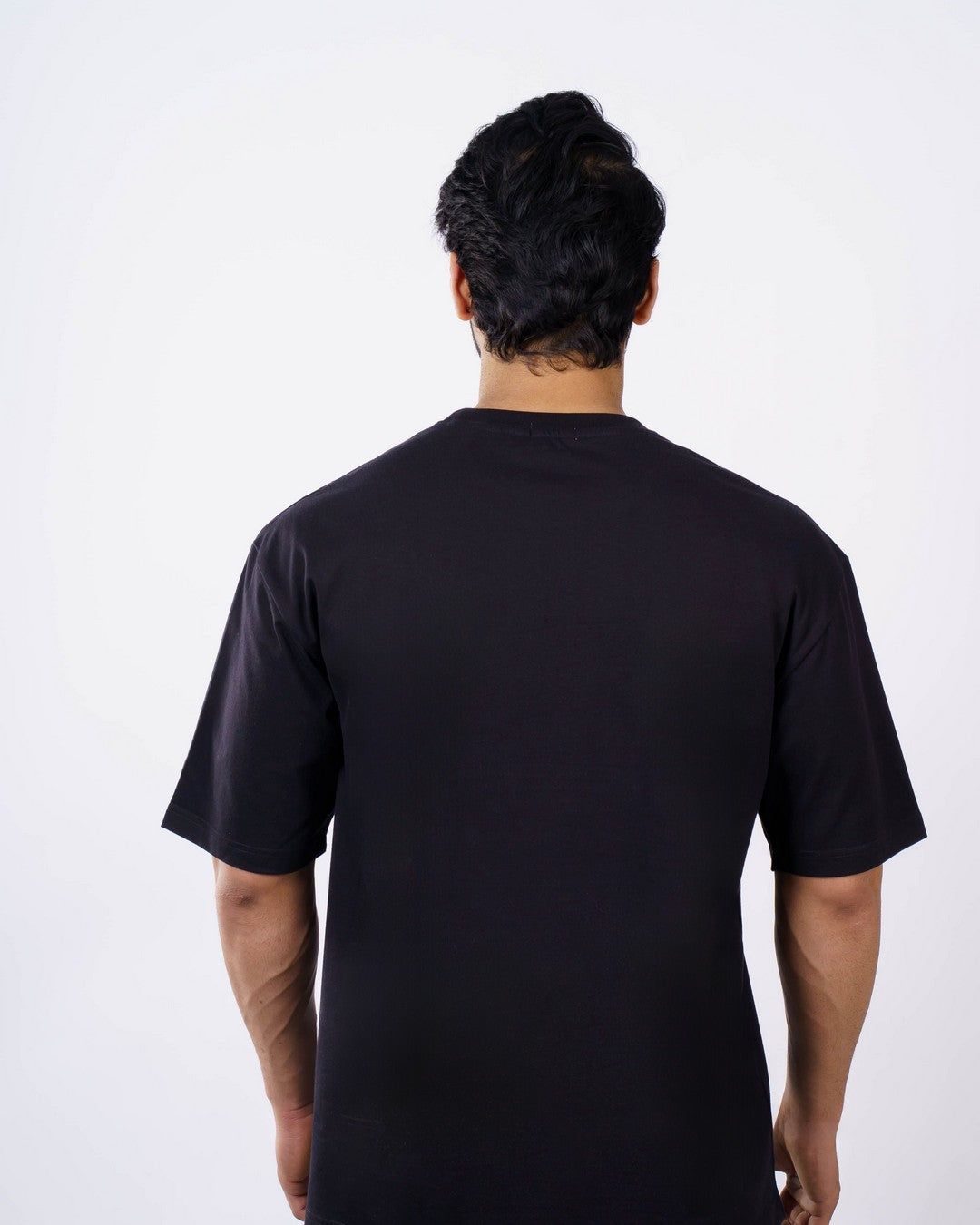 Back view of oversized fit Orthopedician Printed Tshirt For Men by Bandar Baant Collections in solid black