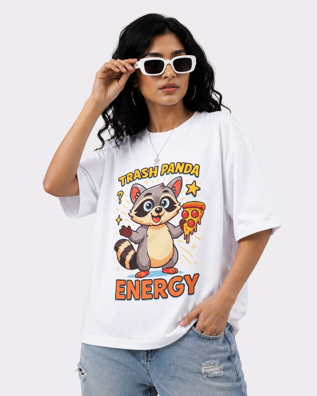 Oversized T-Shirt For Women with Trash Panda Energy cartoon print worn with sunglasses and ripped jeans