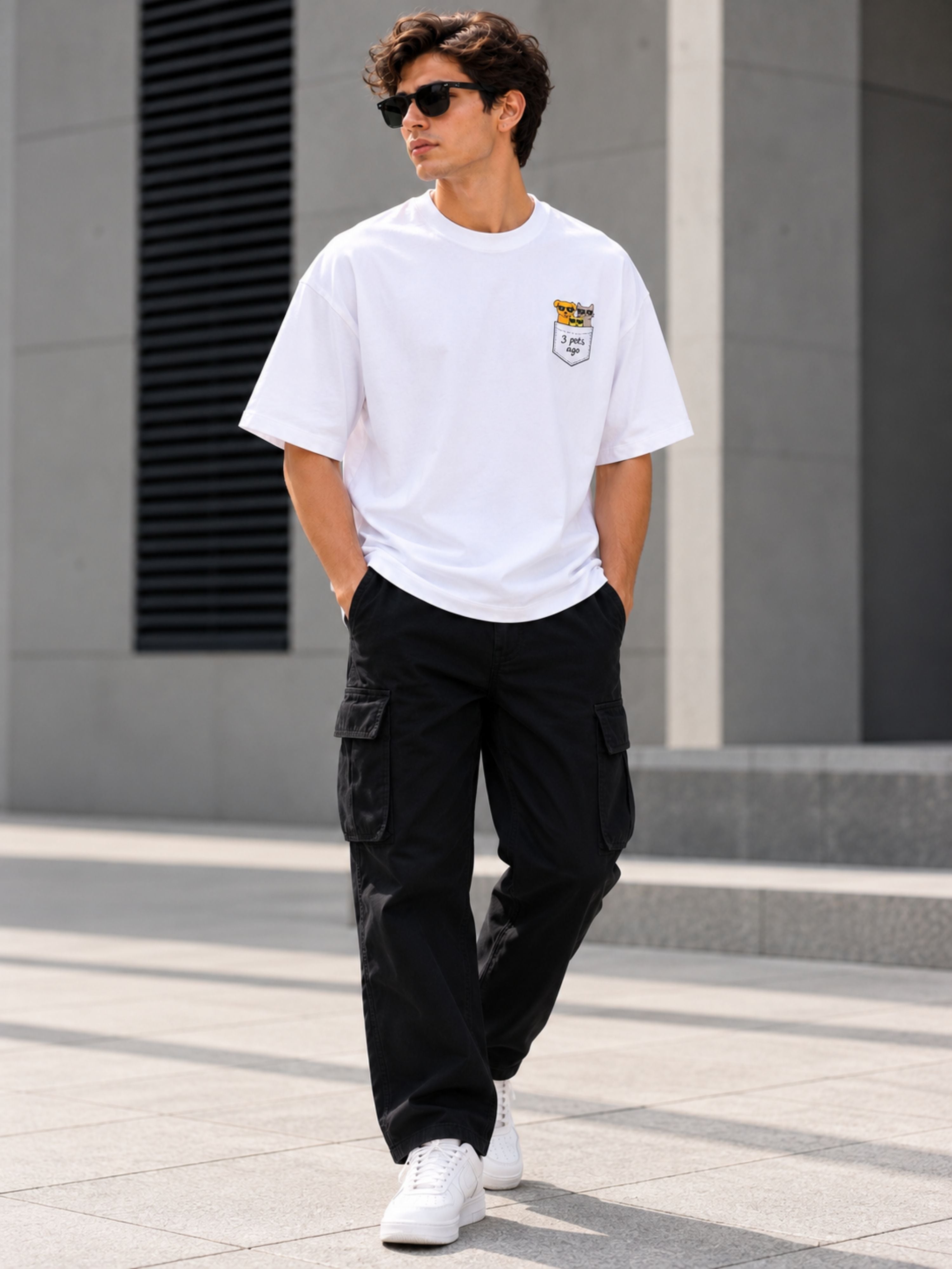 White oversized fit Pet Lover Tshirt For Men from Bandar Baant Collections worn with black cargo pants and white sneakers