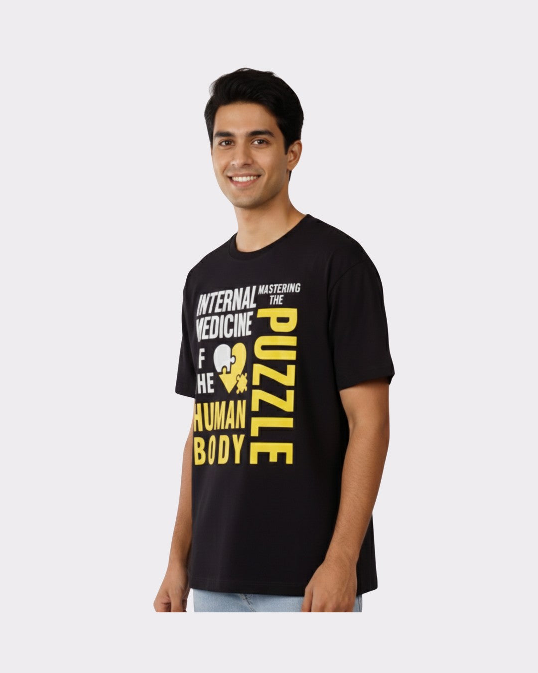 Physician Oversized Tshirt For Men in black with medical graphic print worn by smiling male model