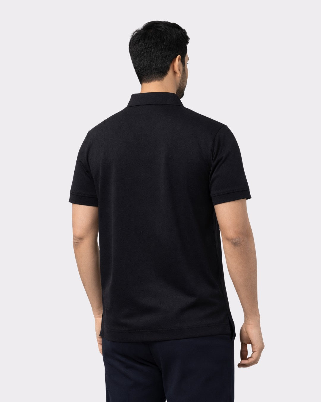 Back view of man wearing Premium Regular Fit Polo T-shirt For Men in black from Bandar Baant Collections