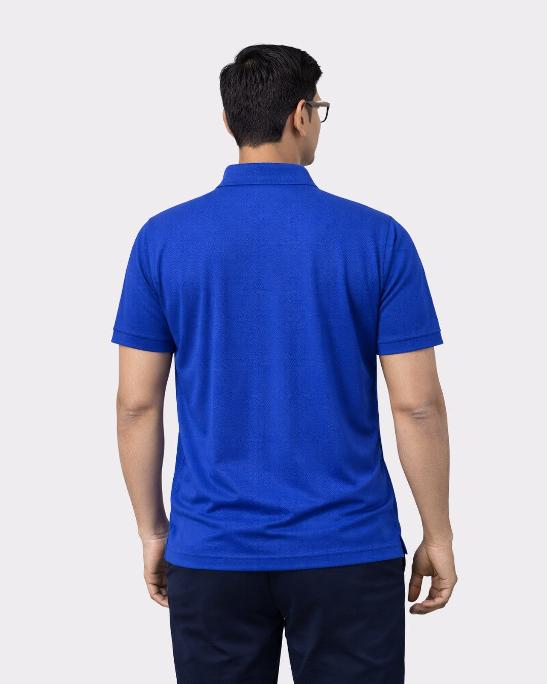 Back view of a man wearing a blue Premium Regular Fit Polo T-shirt For Men by Bandar Baant Collections