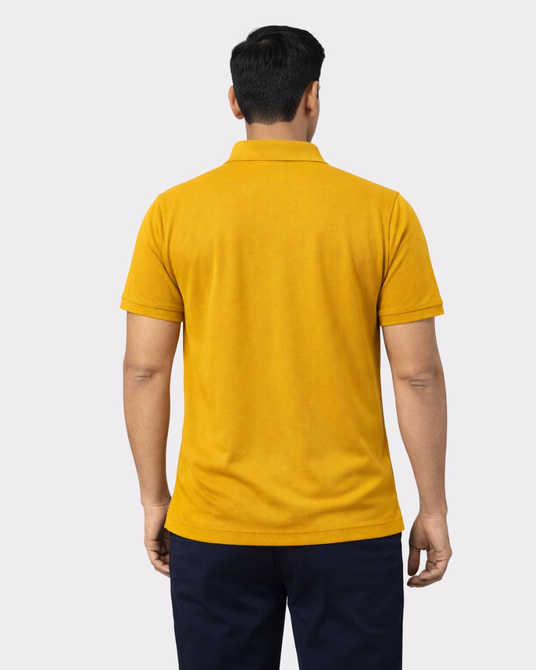 Man wearing mustard yellow oversized fit Premium Regular Fit Polo T-shirt For Men shown from back