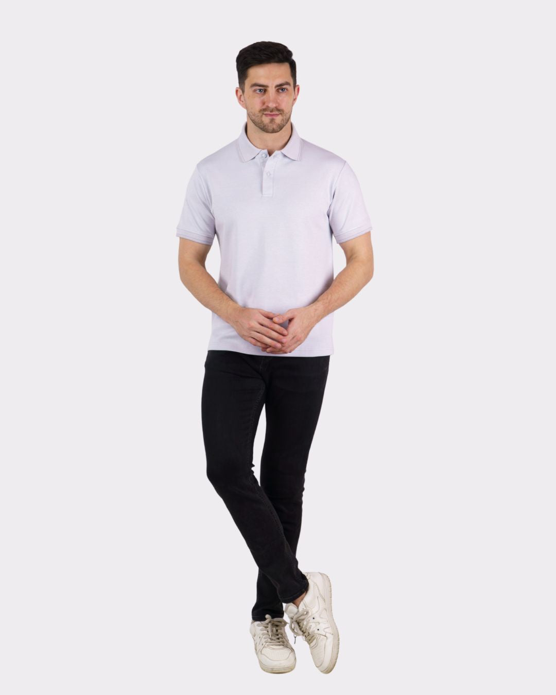 Man wearing a Premium Polo T-Shirt for Men in light color paired with black pants and white sneakers