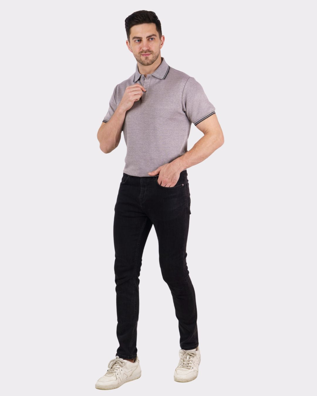 Man wearing a grey Premium Polo T-Shirt for Men from Bandar Baant Collections paired with black pants and white sneakers