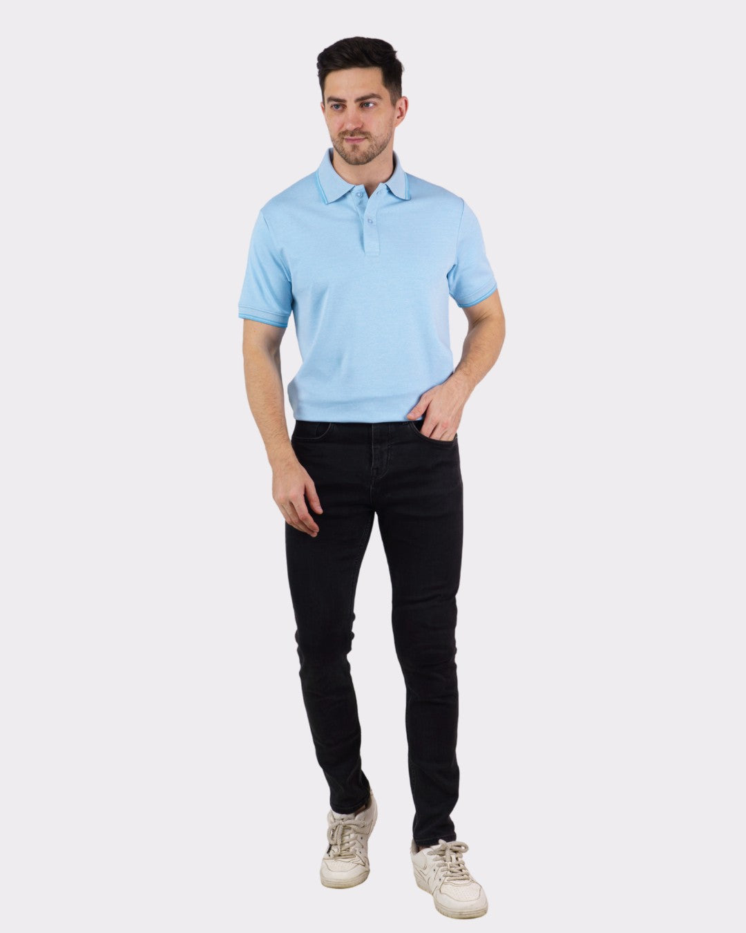 Man wearing a light blue Premium Polo T-Shirt for Men paired with black jeans and white sneakers
