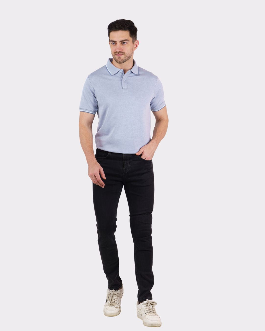 Man wearing a light blue Premium Polo T-Shirt for Men with black jeans and white sneakers
