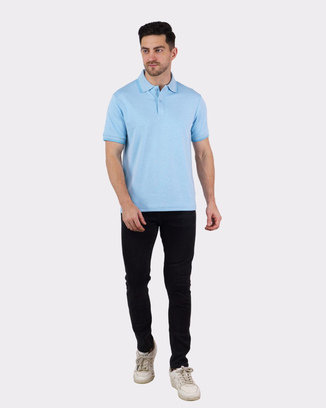 Man wearing a light blue Premium Polo T-Shirt for Men paired with black pants and white shoes