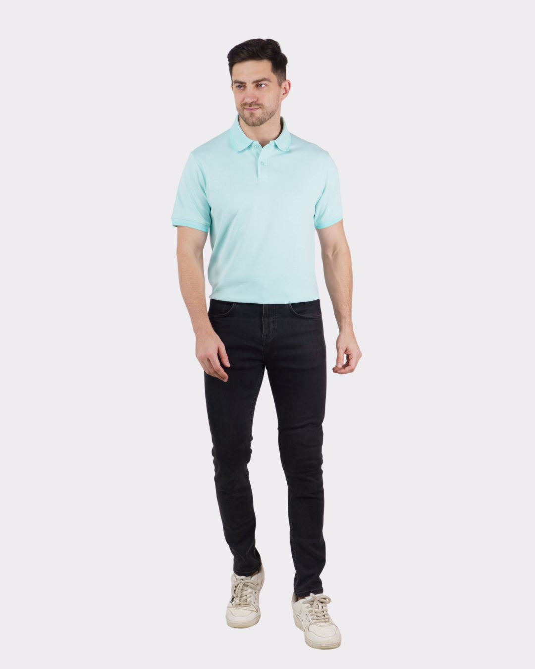 Man wearing light blue oversized fit Premium Polo T-Shirt for Men paired with black jeans and white sneakers