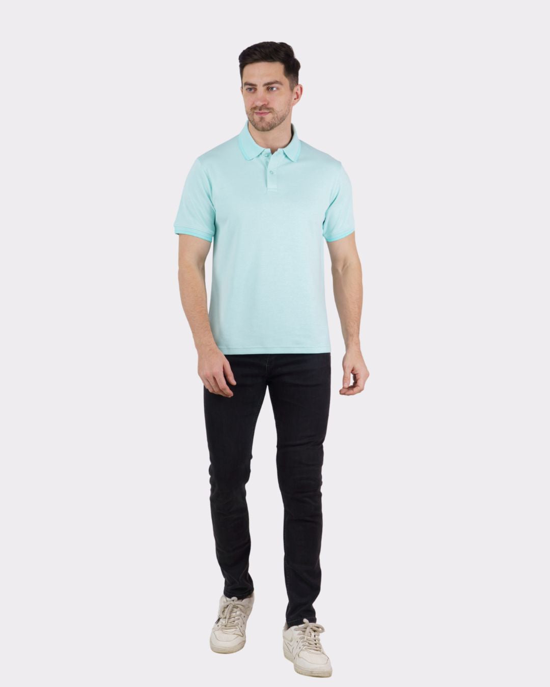 Man wearing light blue Premium Polo T-Shirt for Men paired with black pants and white sneakers
