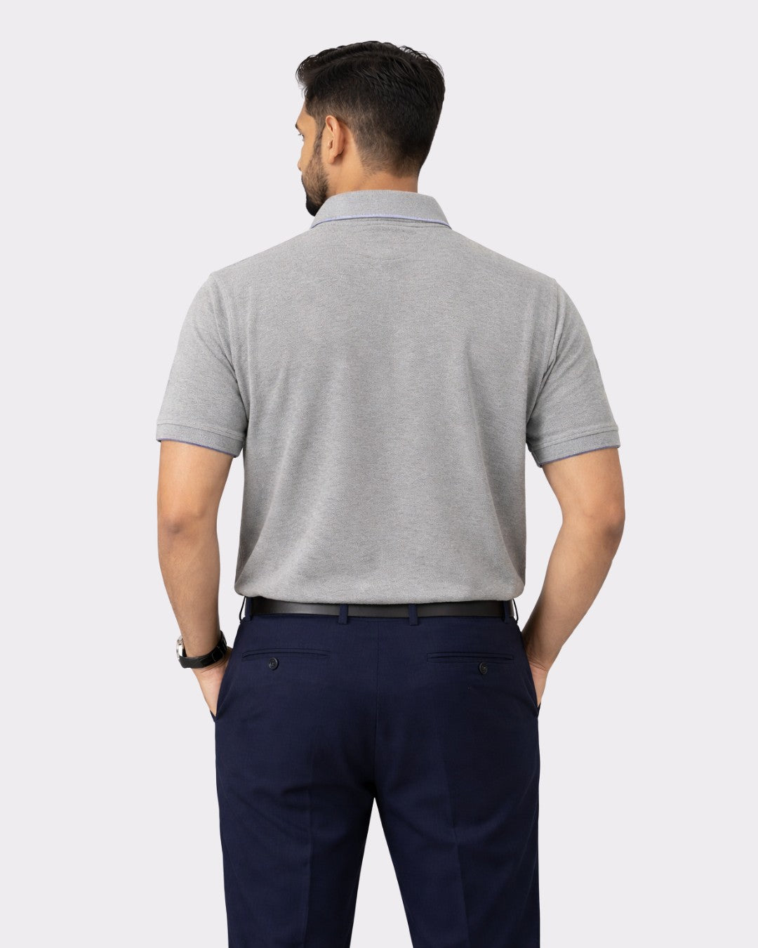 Back view of a man wearing a Regular Fit Premium Cotton Polo T-Shirt for Men in gray with navy pants