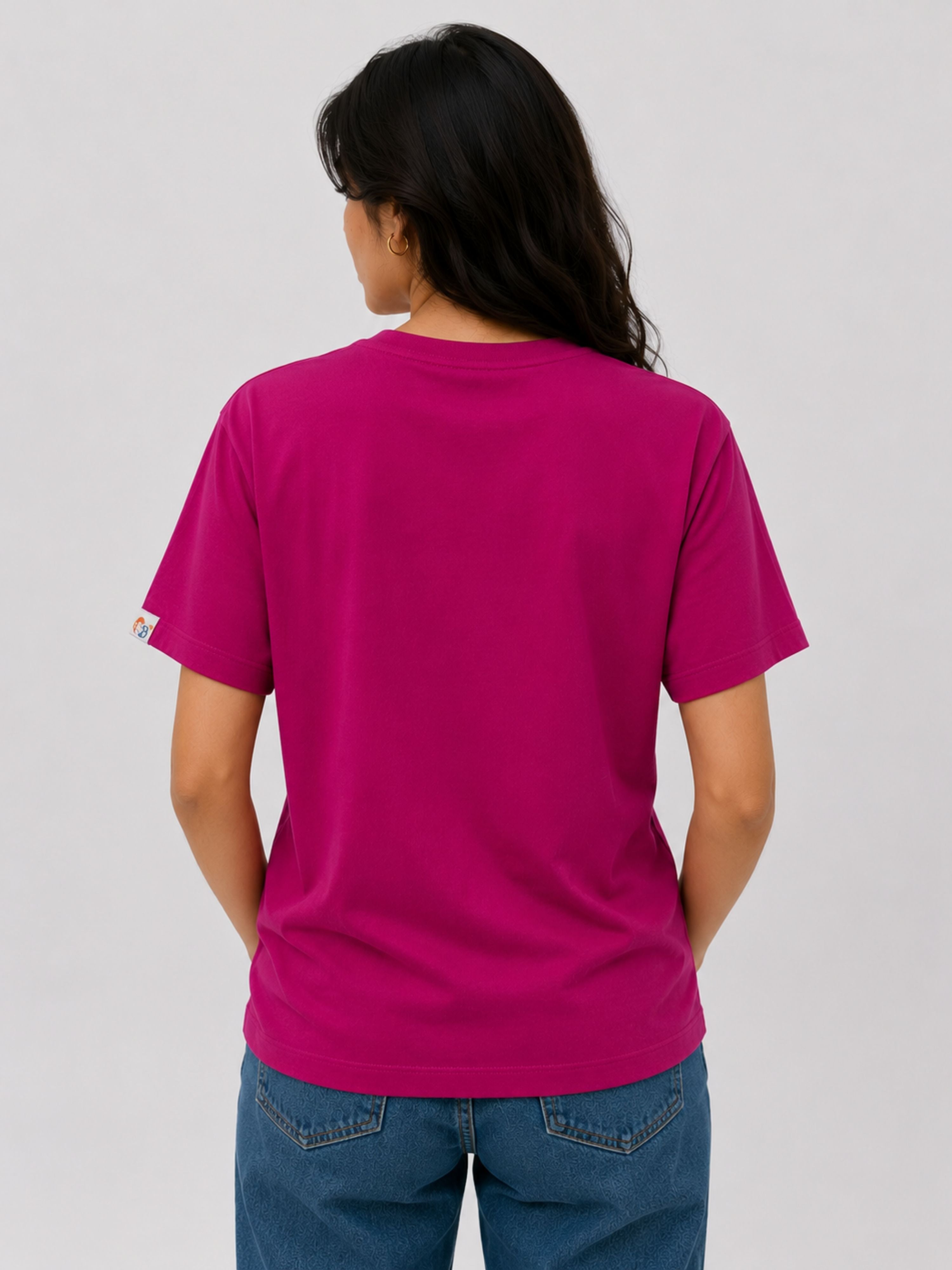 Back view of a woman wearing a fuchsia Regular Fit T-Shirt for Women paired with blue jeans
