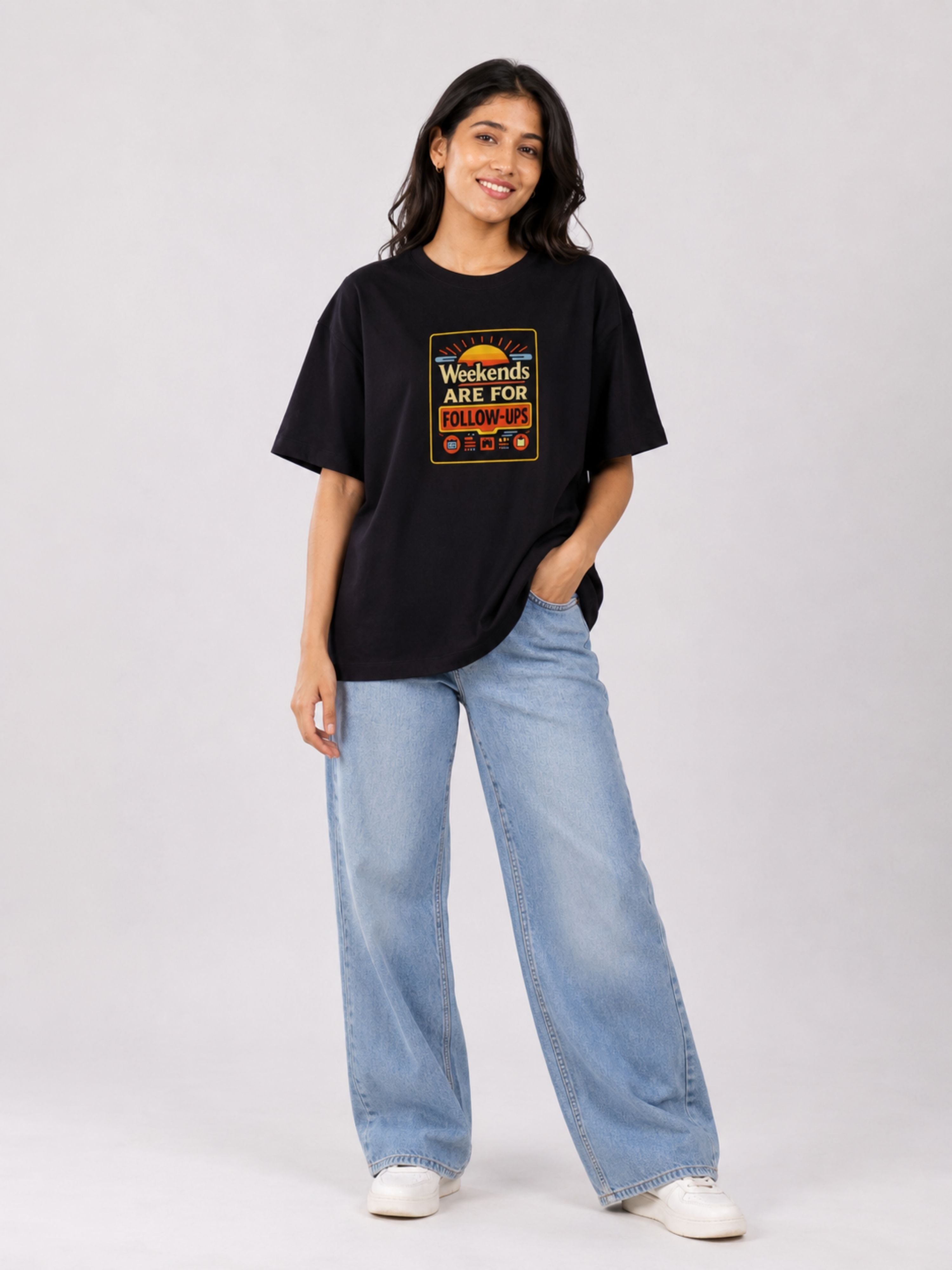 Sales Executive Oversized Tshirt For Women in black with graphic print worn with light blue wide-leg jeans
