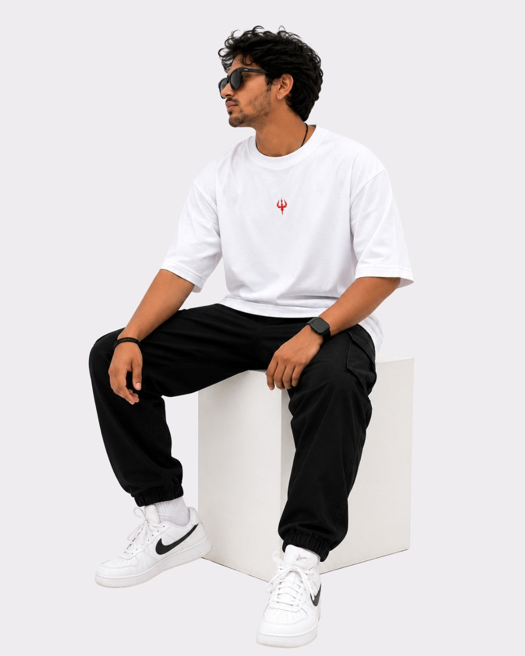 Sanatan Dharma OM NAMAH SHIVAY T-shirt For Men oversized white T-shirt with red symbol worn by seated man
