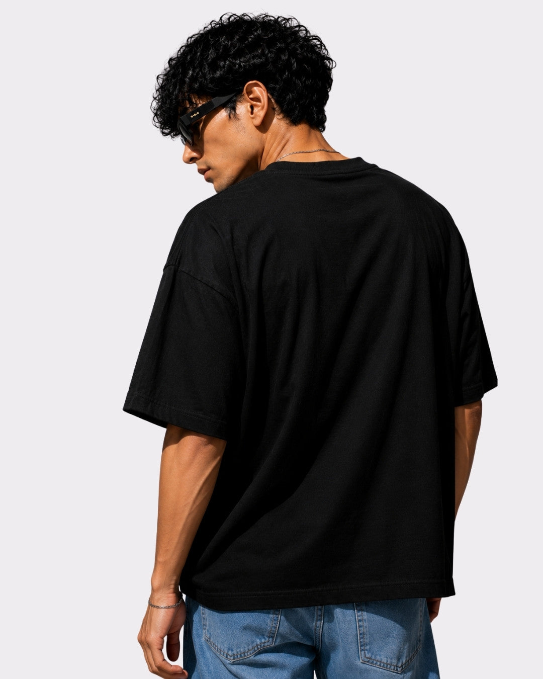 Choreographer Oversized T-shirt For Men in black worn by model with sunglasses showing back view