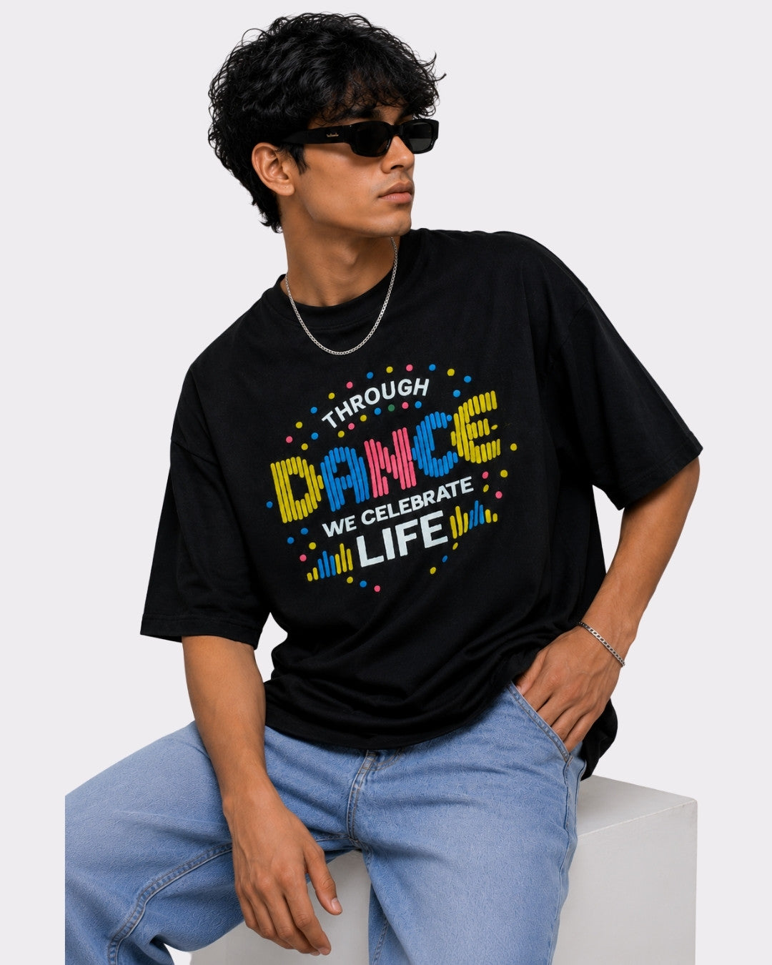 Choreographer Oversized T-shirt For Men black with colorful dance graphic worn by man in sunglasses